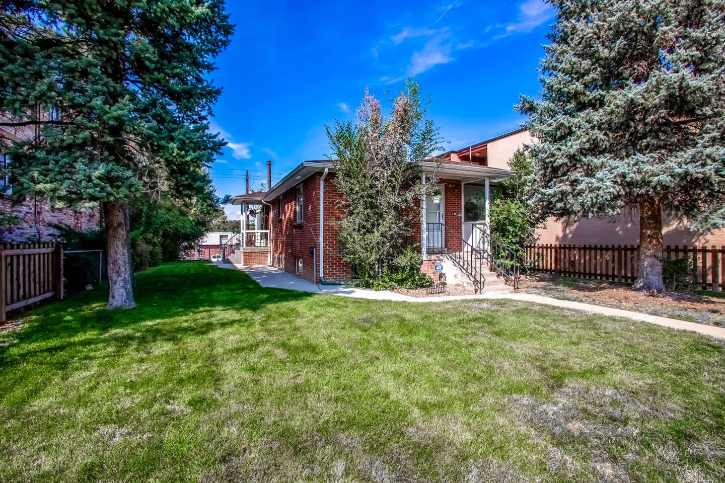 Private Yard, a rare in the city.  Enjoy our secluded sitting area fenced off by the trees/shrubs & raised platform as you enjoy outside time with those in your group while the pets play.