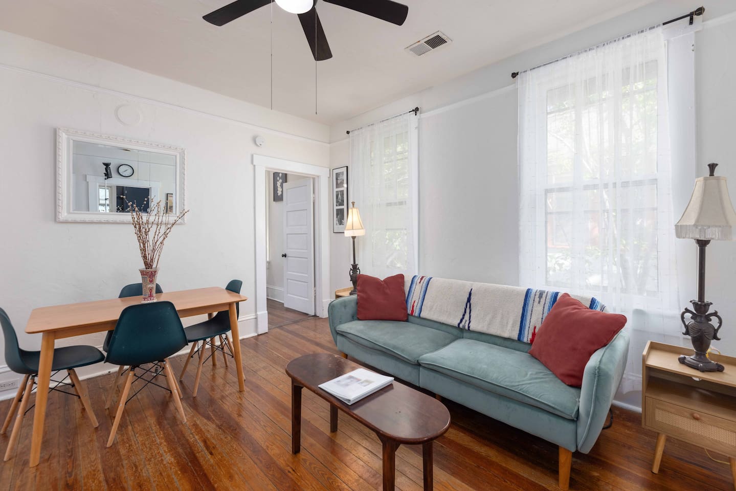 Mid-Century designed Living room with fold-down futon that comfortably sleeps one. Dining table for 4.