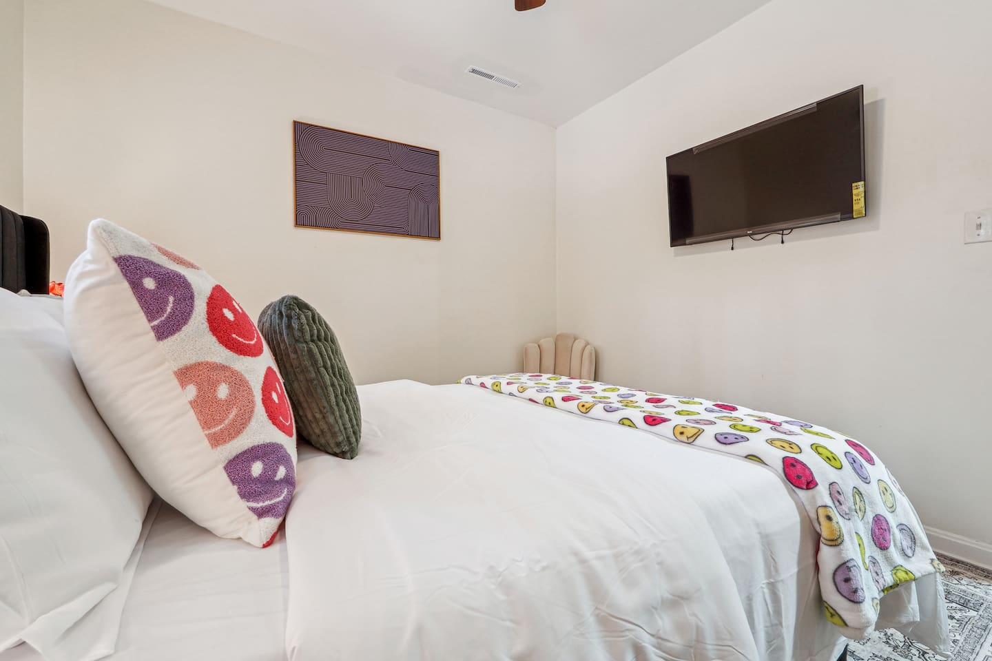 A comfortable bedroom featuring a bed, a ceiling fan, a window, a TV, and a closet — a cozy space to rest and relax.
