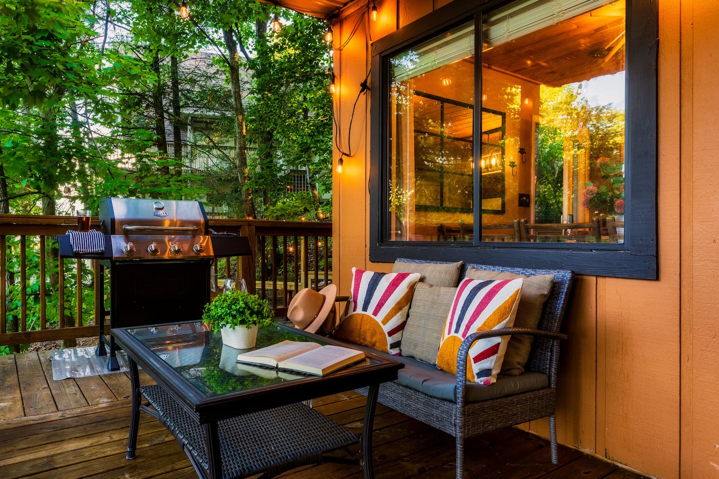 The main level porch includes a propane grill, private hot tub and outdoor seating.