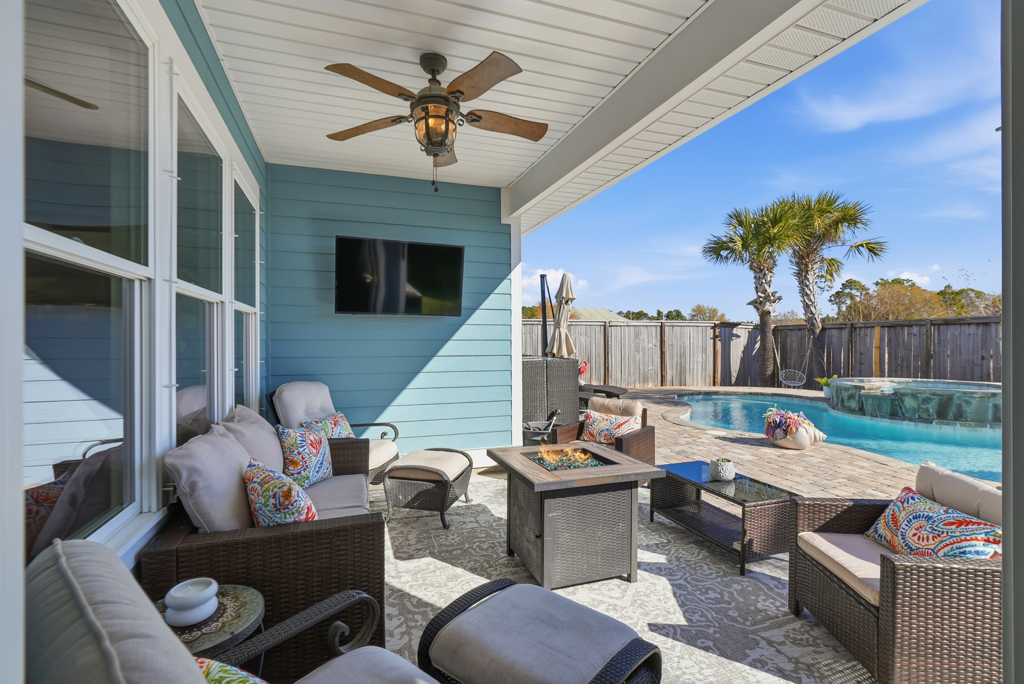 Covered outdoor lounge and dining area beside the private pool—ideal for family vacations.
