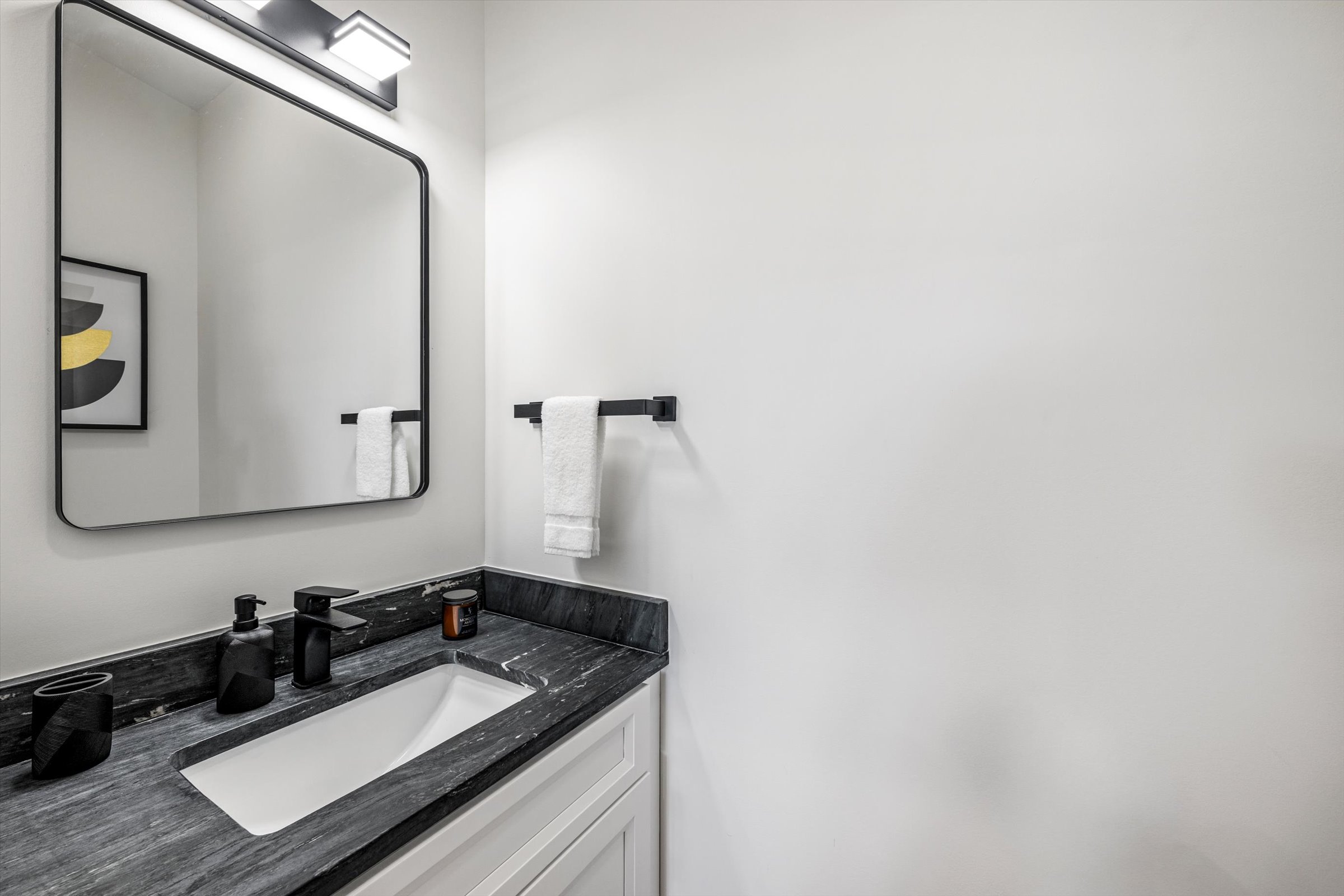 {Powder Bath} Clean, modern powder bath with vanity, mirror, and essentials — conveniently located for easy access from main living areas.