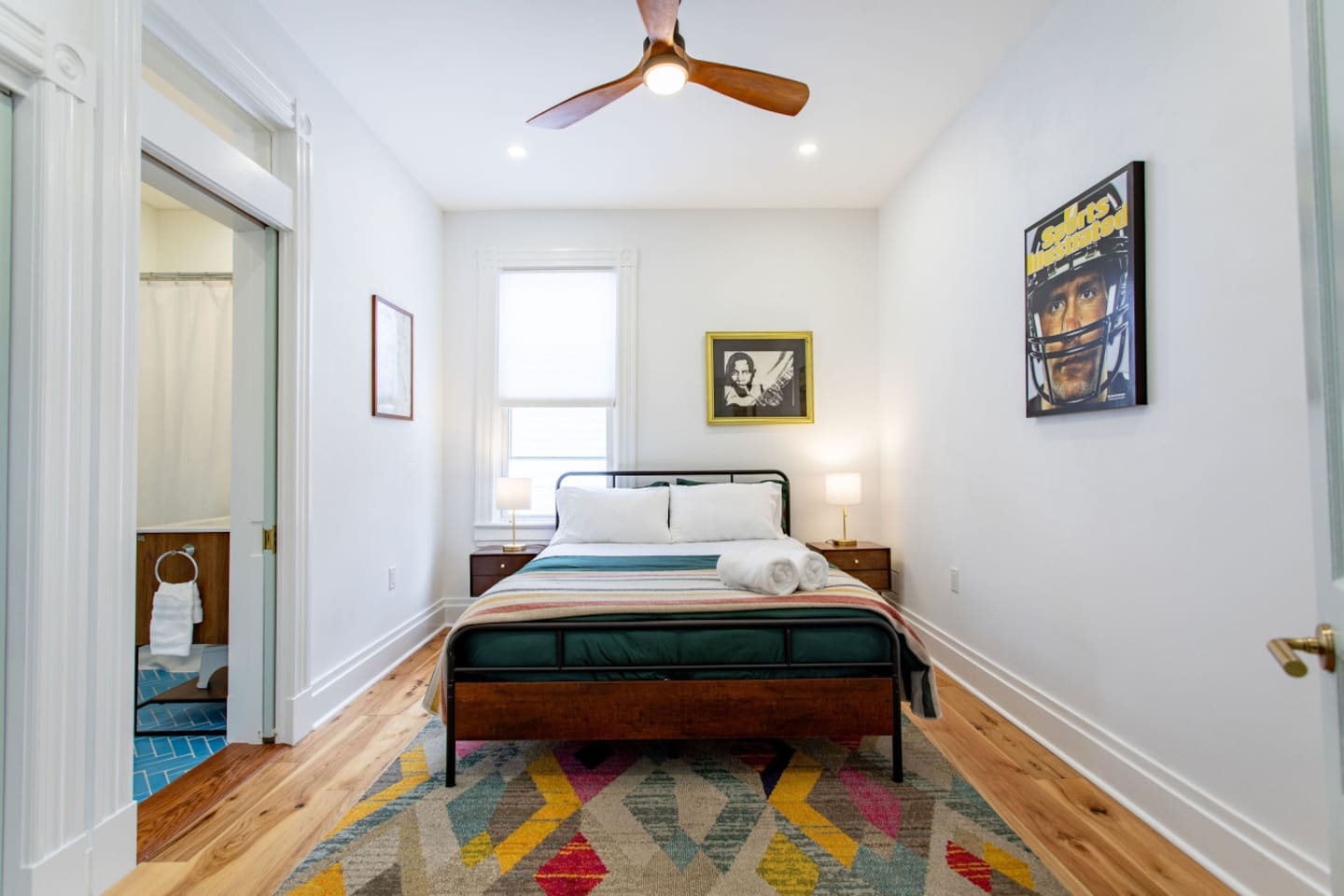 A spacious bedroom featuring a large window that fills the room with natural light, creating an airy and open atmosphere perfect for relaxation.