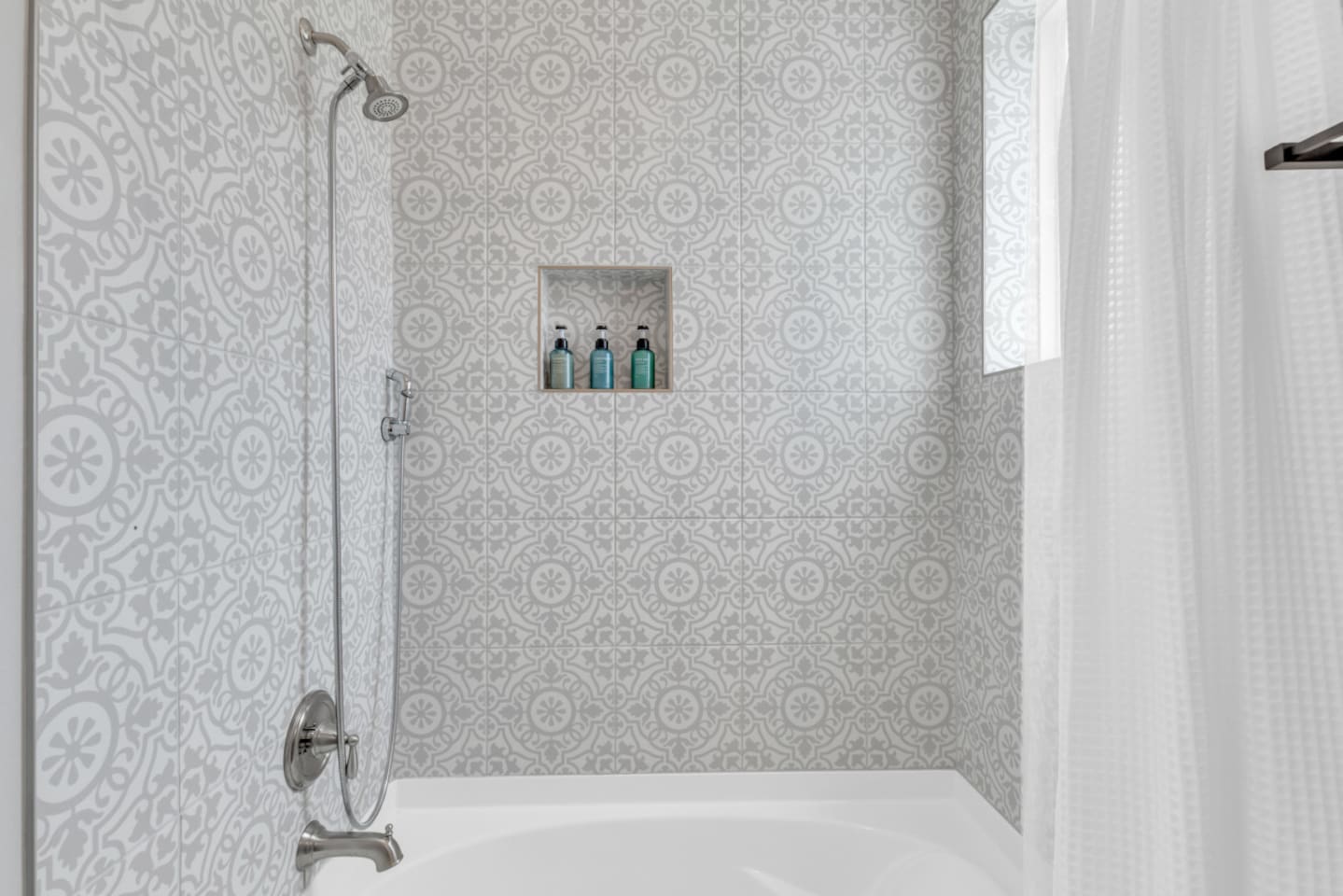 Relaxing tub with niche shelving for spa-like experience.