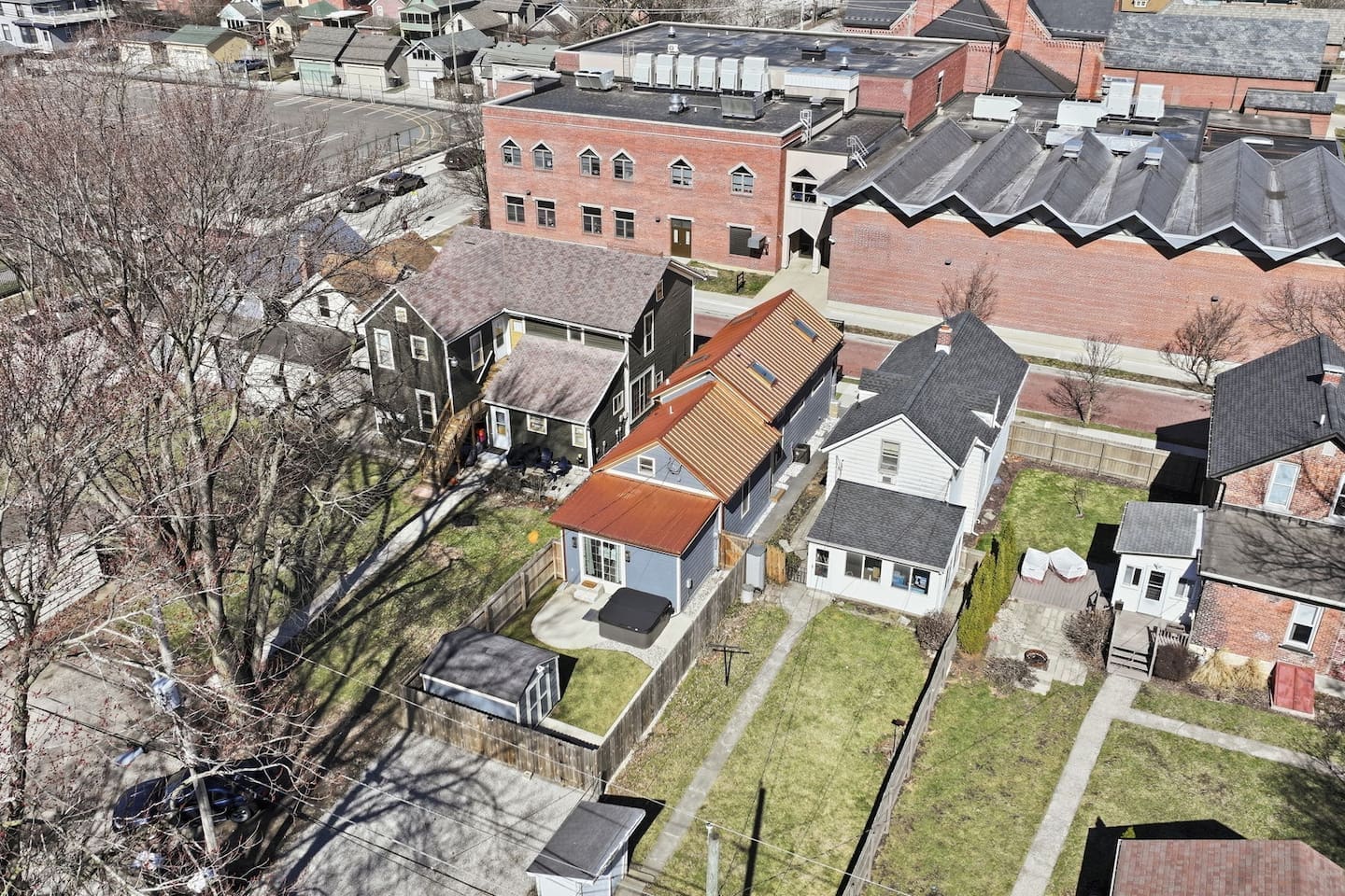 Aerial view showcasing the property’s backyard layout and surrounding neighborhood