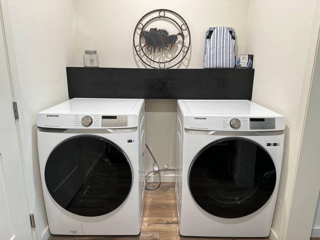 Laundry detergent and wool balls are there for your use along with an iron and board.    On the opposite side is a garment rack for jackets or hanging your laundry.   Shoe storage and bench to help you take off your shoes.  