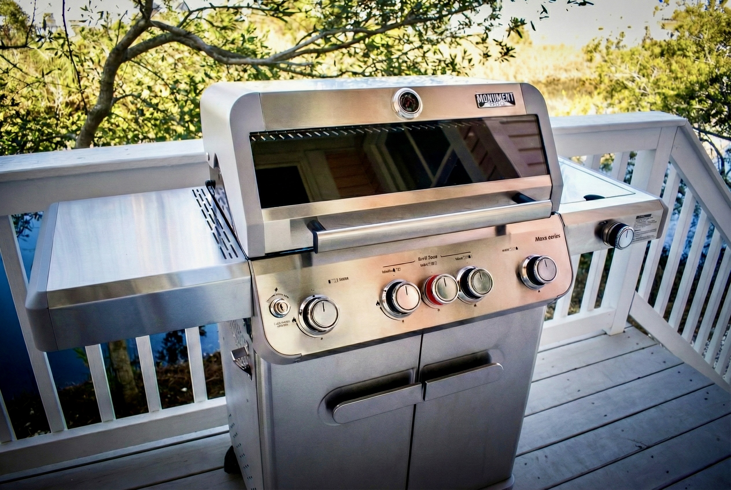 Upgrade your vacation meals with our premium Monument gas grill. This 4-burner stainless steel BBQ features a side burner for prepping sides and a convenient glass viewing window, so you can check your food without lifting the lid and losing heat.