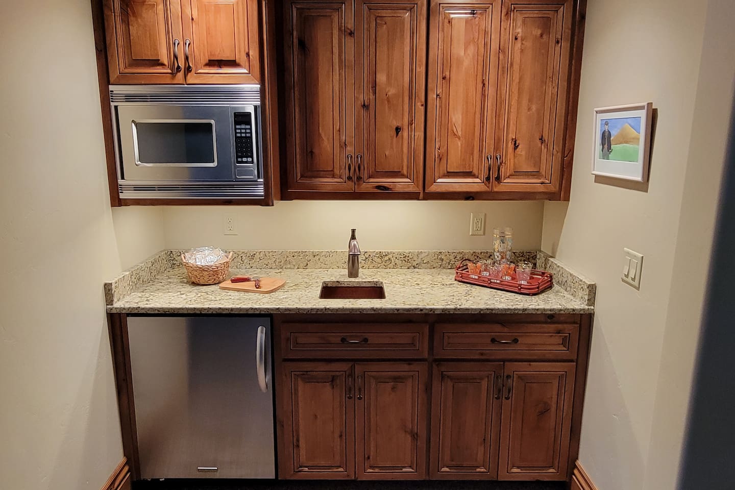 Kitchenette in basement family room for easy entertainment!  Grab a drink from the fridge and toss some popcorn in the microwave!