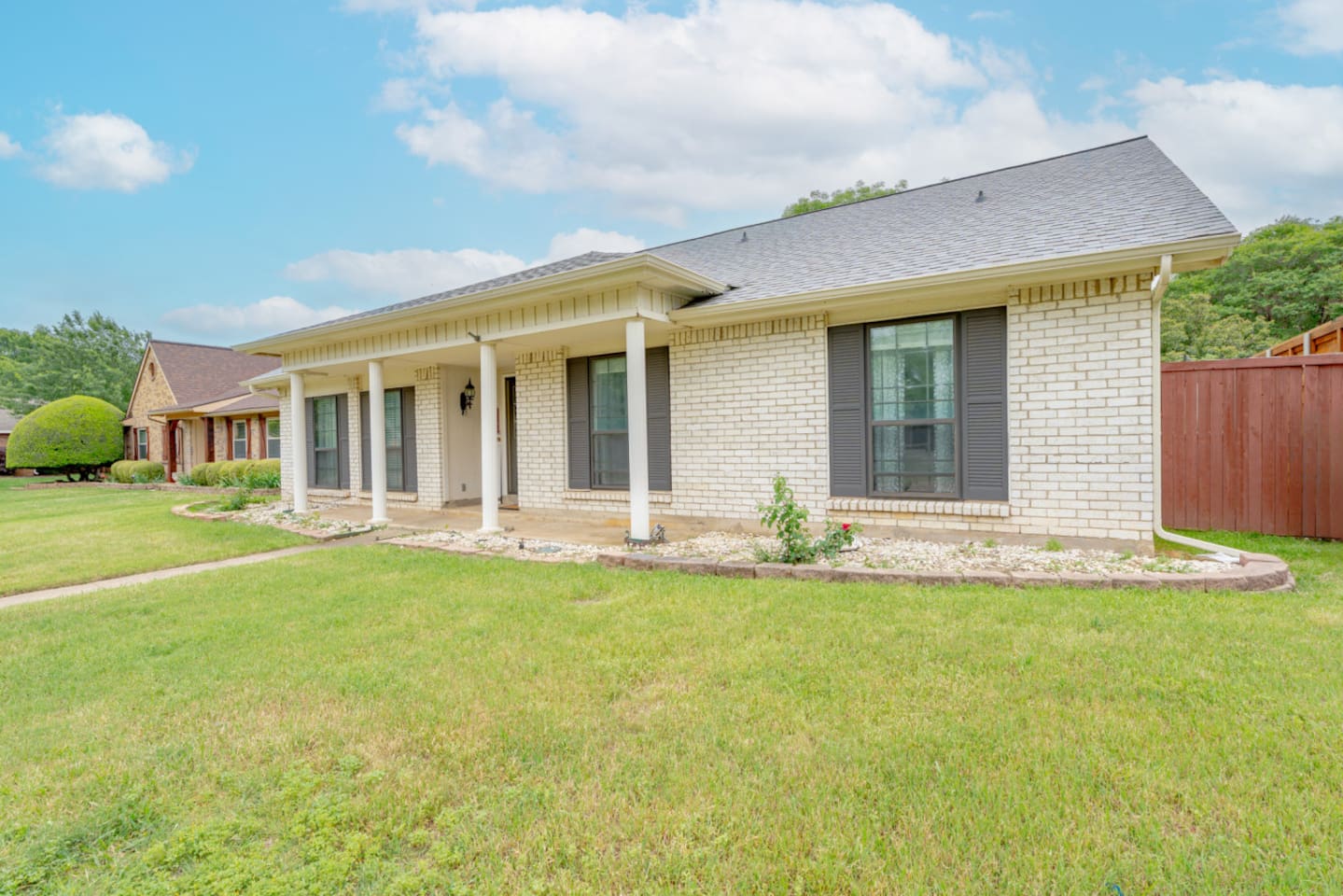 Charming brick exterior with inviting front porch.