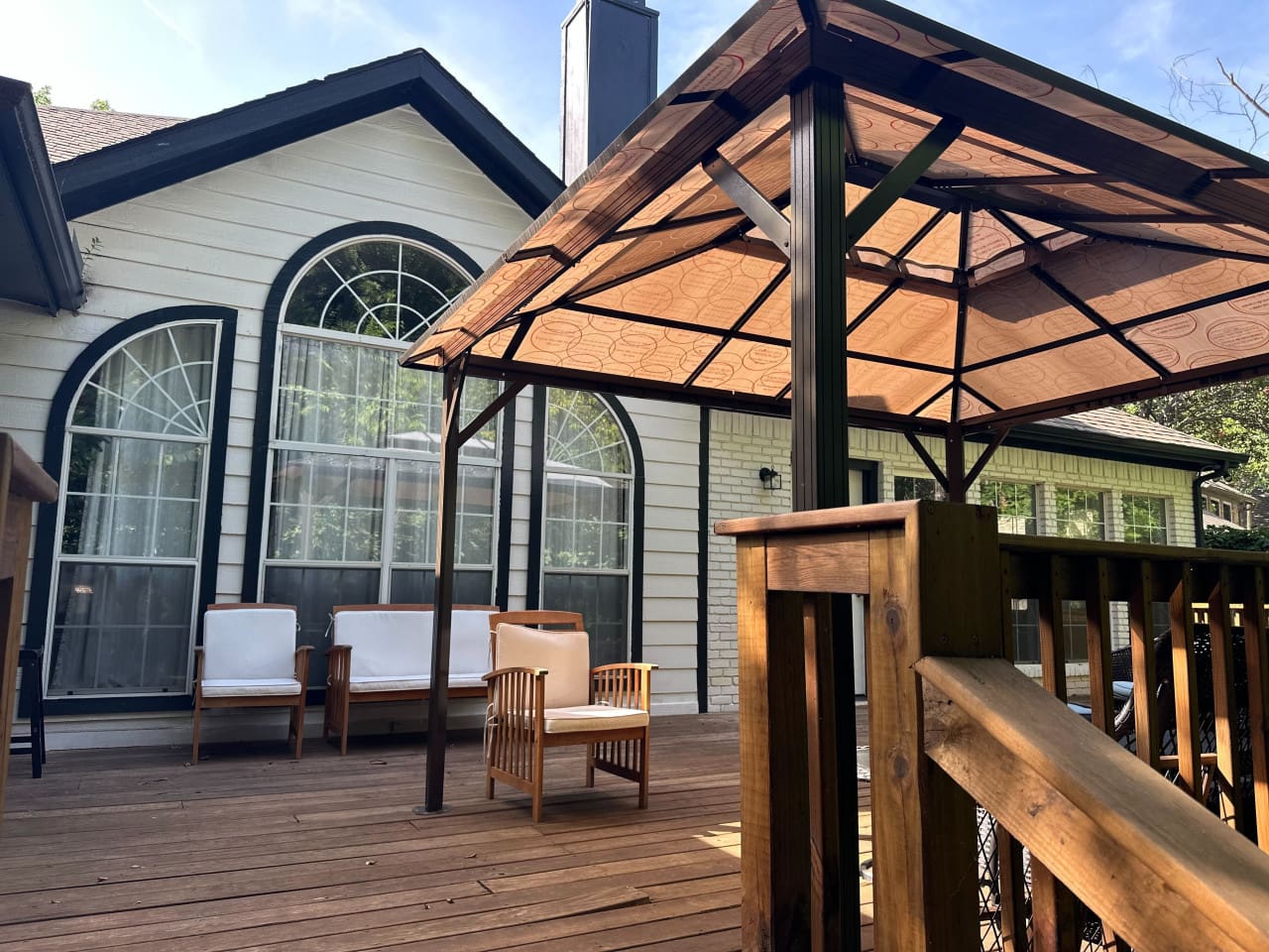 Covered patio with grill for outdoor dining and entertaining.