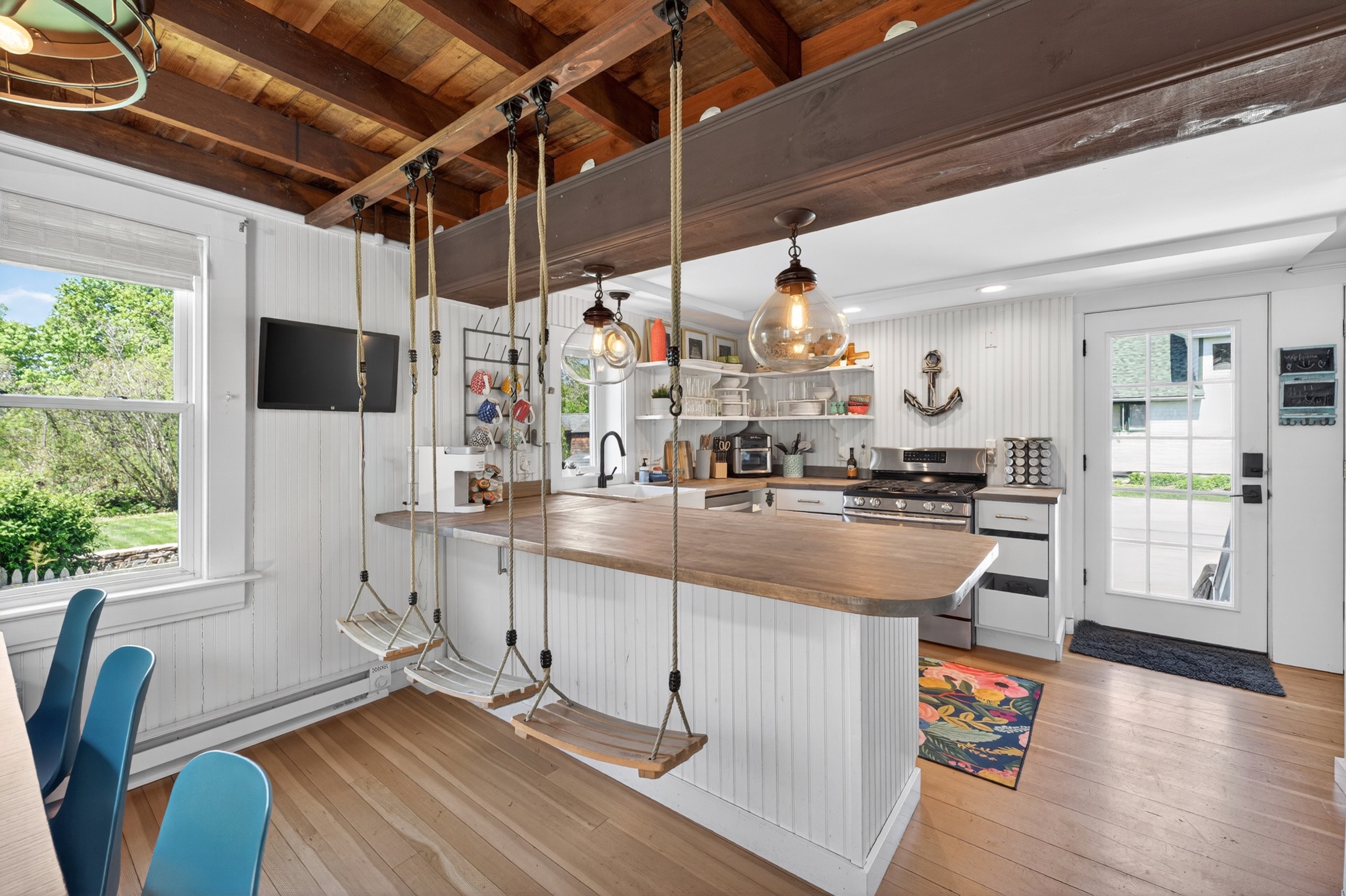 Cool swing bar stools add a fun and unique touch to the space.