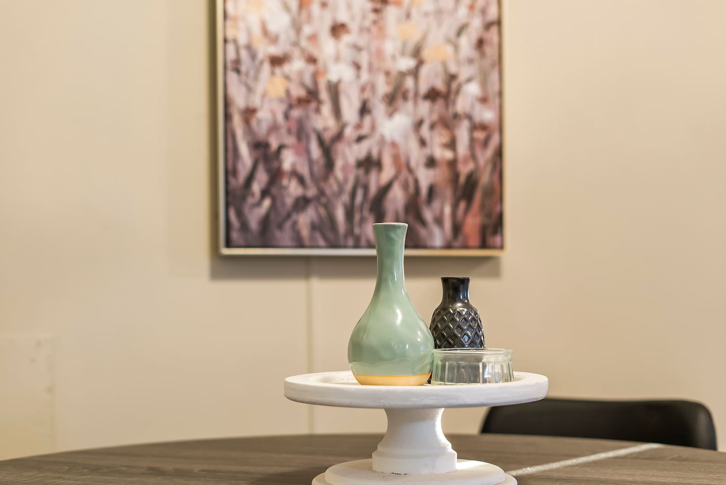 Artful centerpiece with decorative vases, adding a stylish touch to the dining setup.