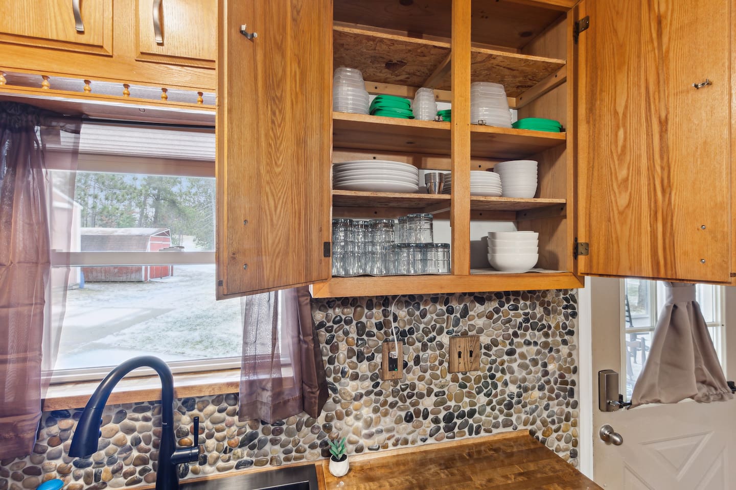 Plenty of dishes for 8 people, as well as utensils located in kitchen island drawers. Tupperware with lids for food you'd like to save.