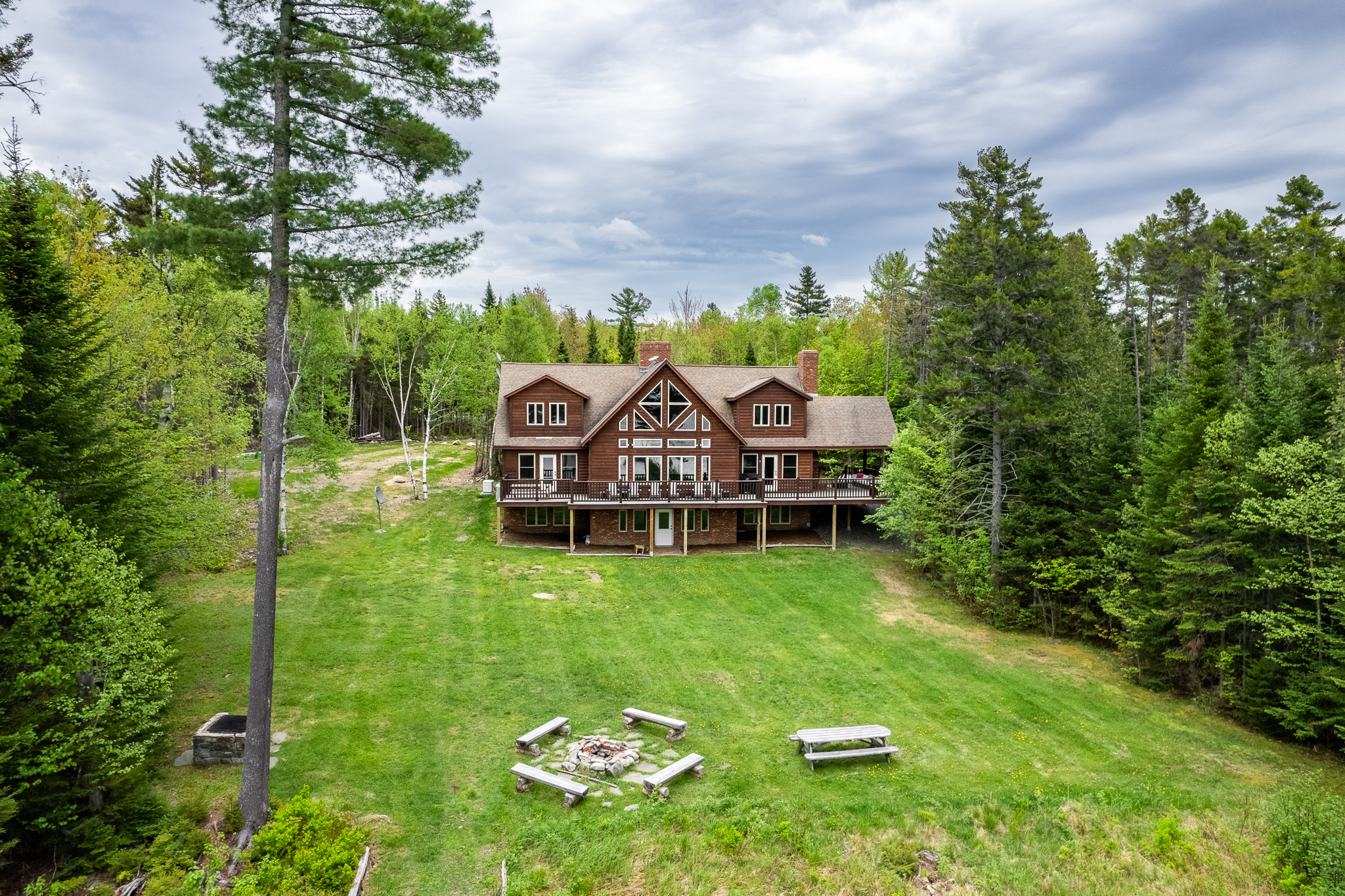 Escape to the back yard overlooking beautiful Lily Bay with amazing sunsets. Play a game of corn hole, gather by a crackling fire with 2 fire pits, or lounge by the your private dock and read a book. An enjoyable spot for everyone to hang out.