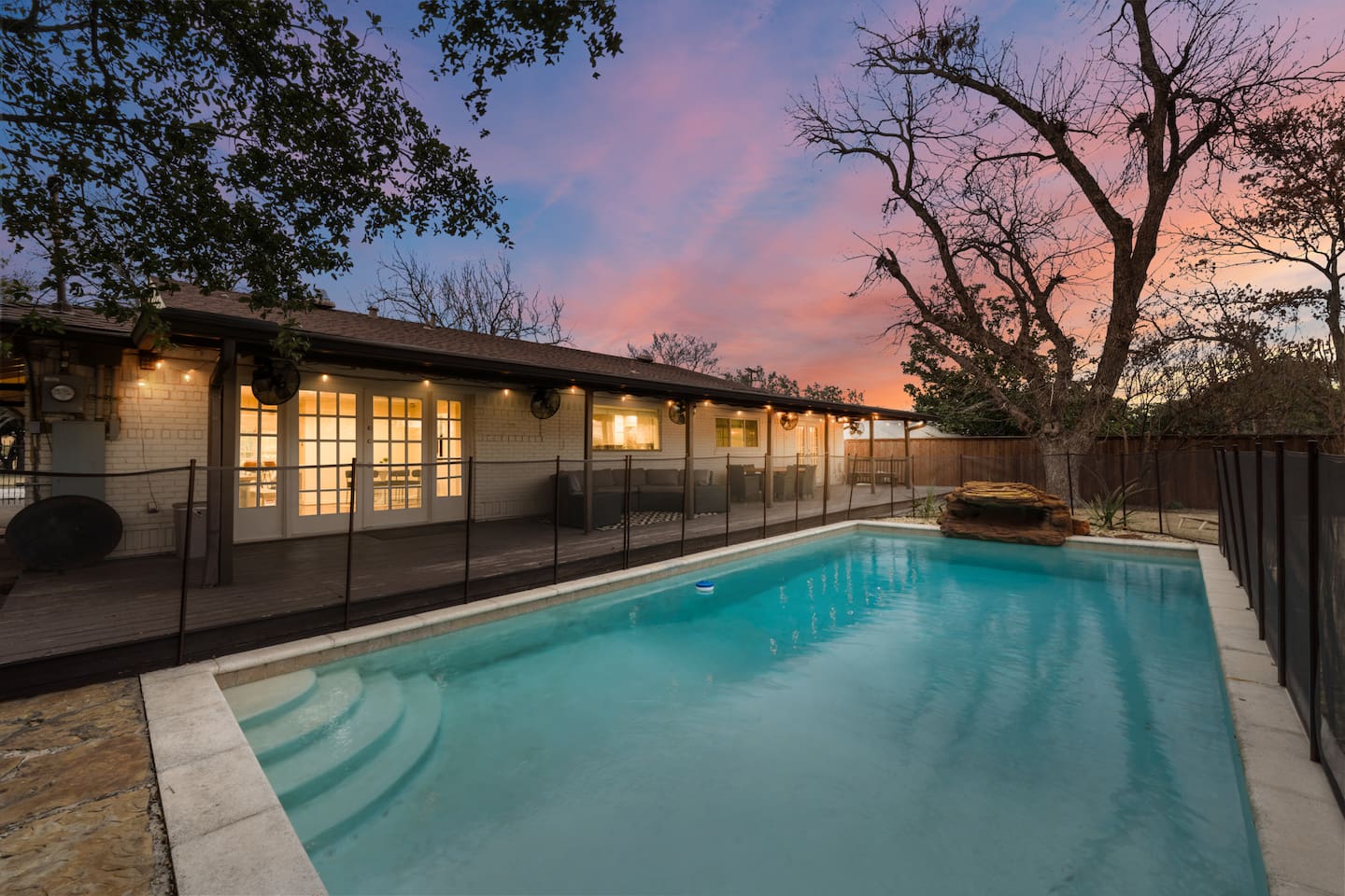 Catch a true Texas sunset in this spacious backyard, adorned with a large pool and ample outdoor seating and amenities! 