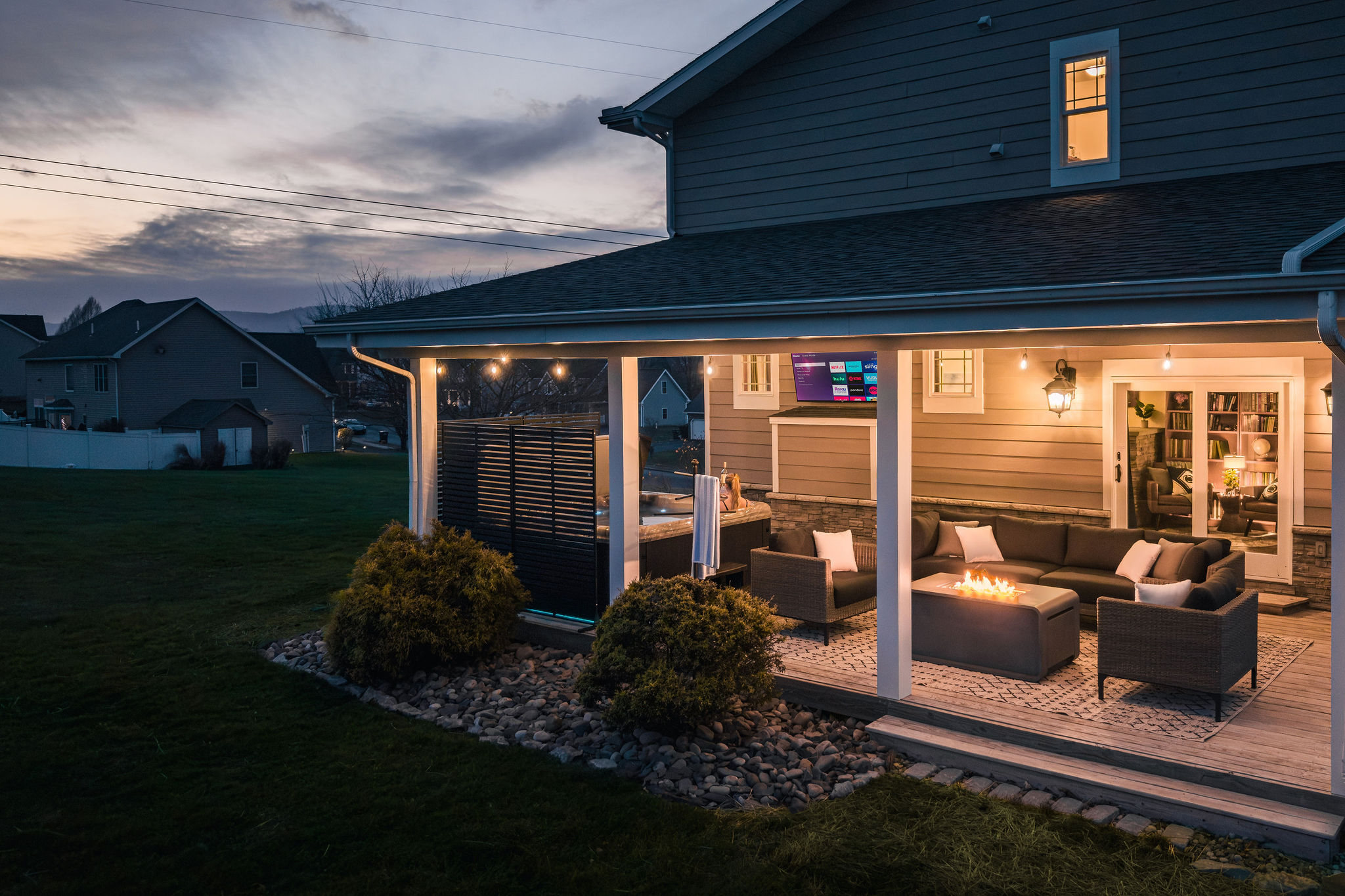 Covered outdoor lounge perfect for evening conversations, morning coffee, or relaxing year-round.