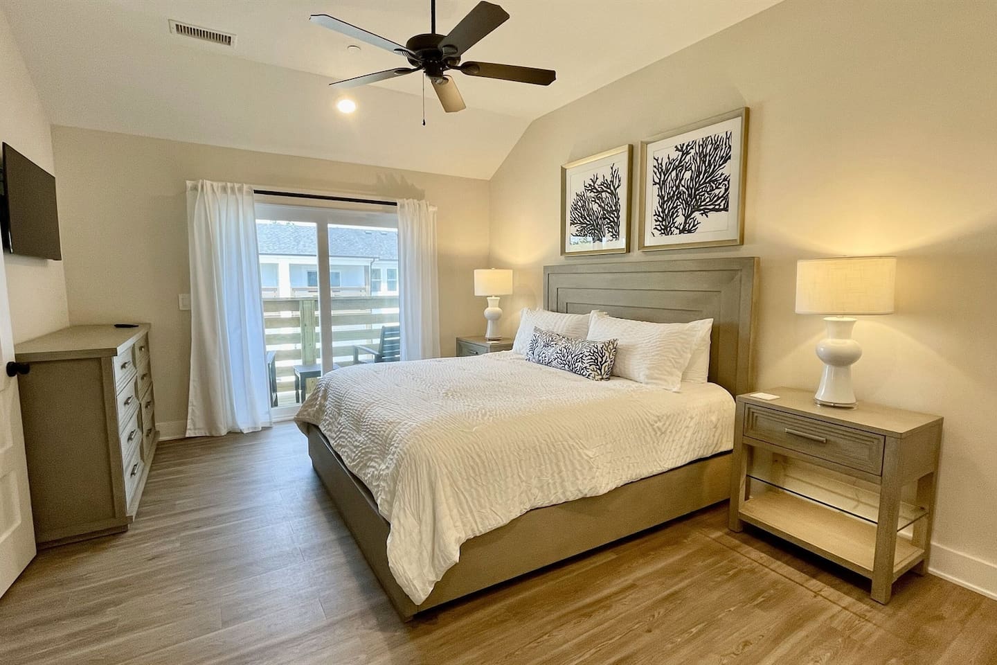 Inviting King bedroom with soft linens, warm lighting, and a restful atmosphere