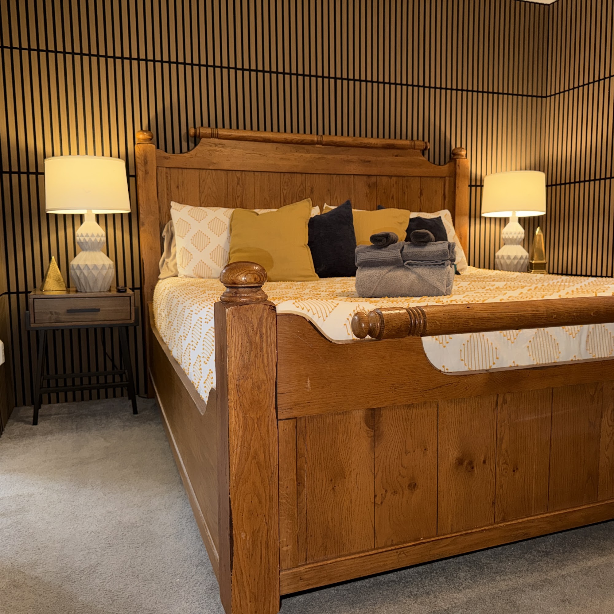 Bedroom 1: king bed with wood-slat accent wall