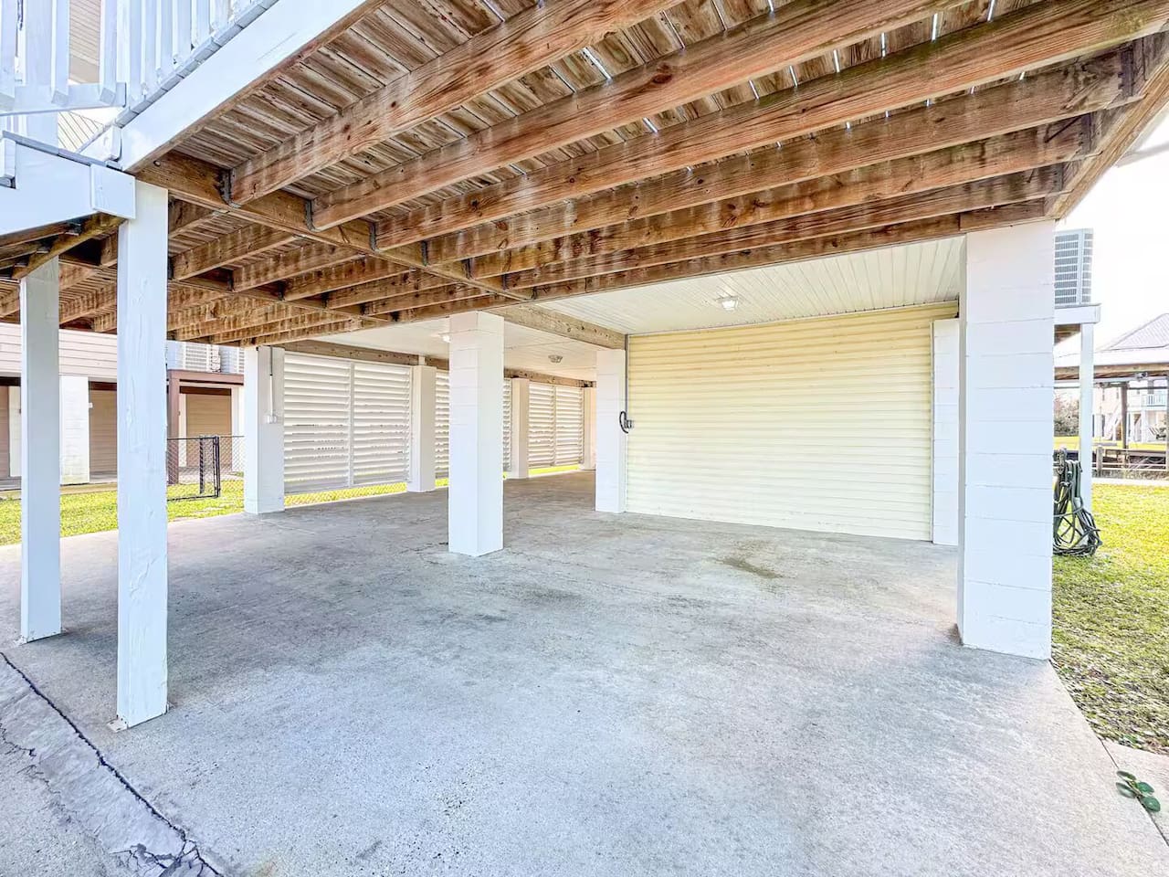 Open covered space with comfortable seating and ample room for lounging, parking, or storing beach gear.