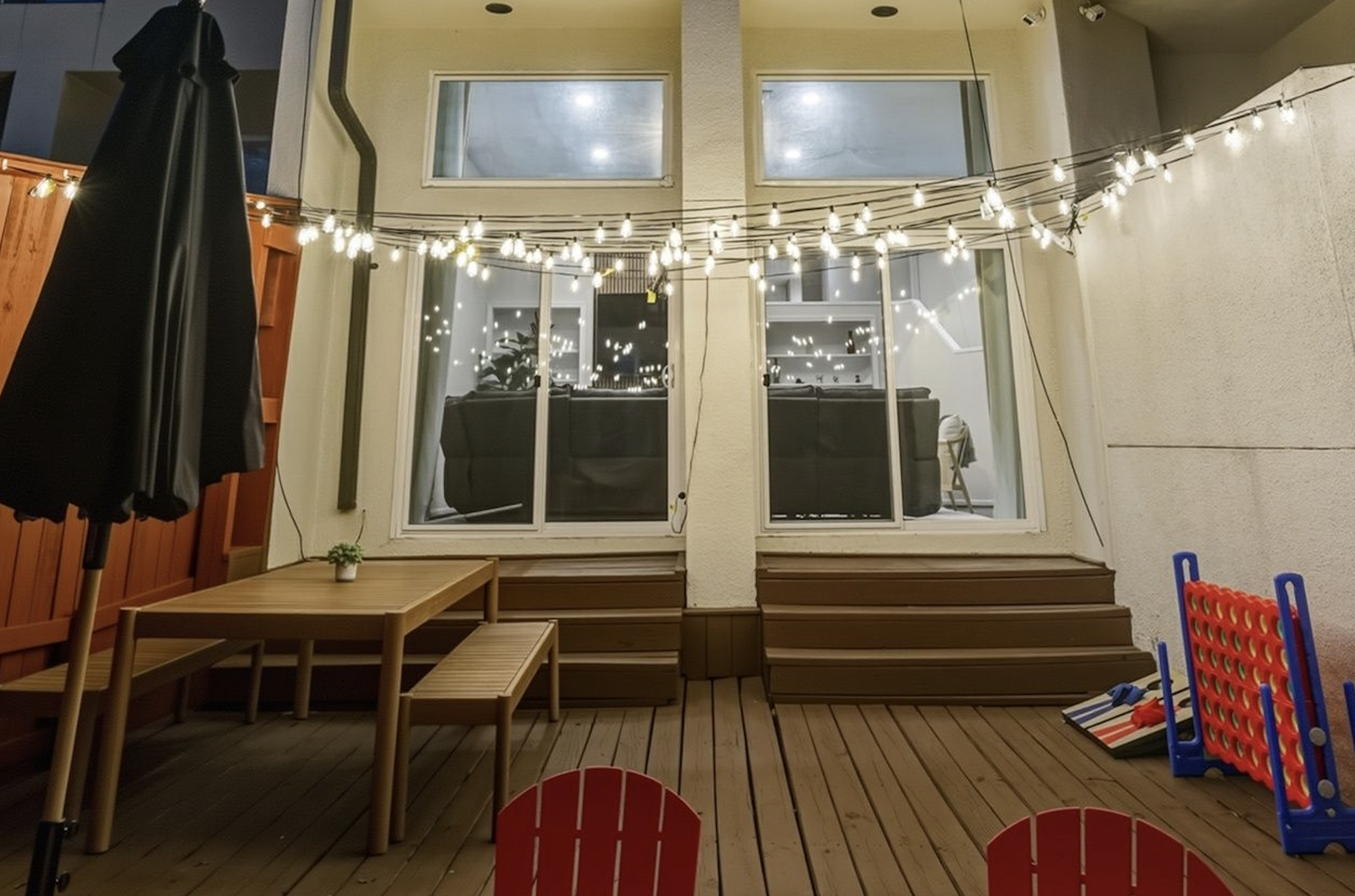 Enjoy outdoor dining, string lights for evening ambiance, and classic yard games including Connect 4 and cornhole.