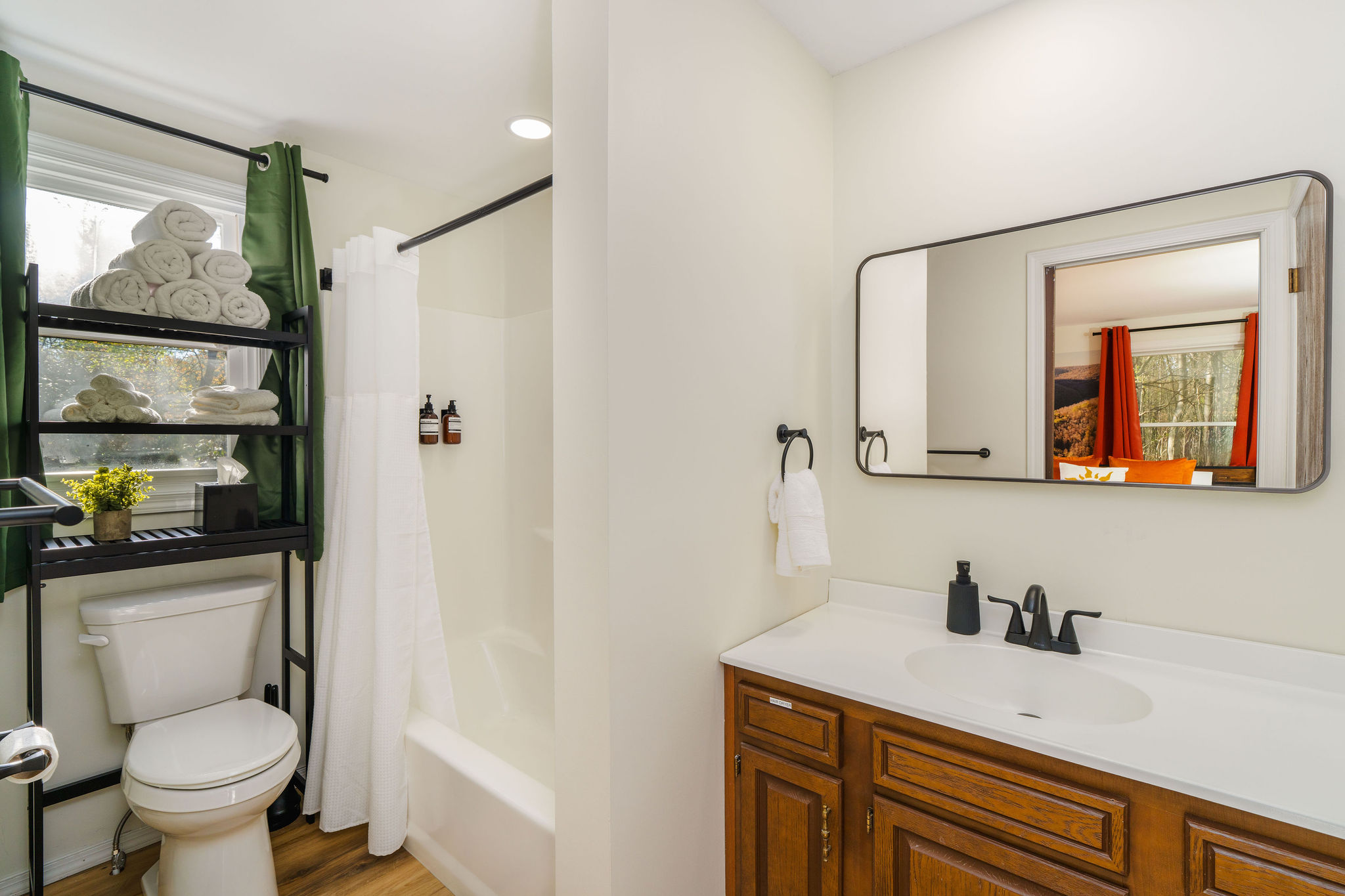 🛁 The main bath (shower/tub combo) serves the bedrooms — with a second full bath downstairs so there's never a wait.