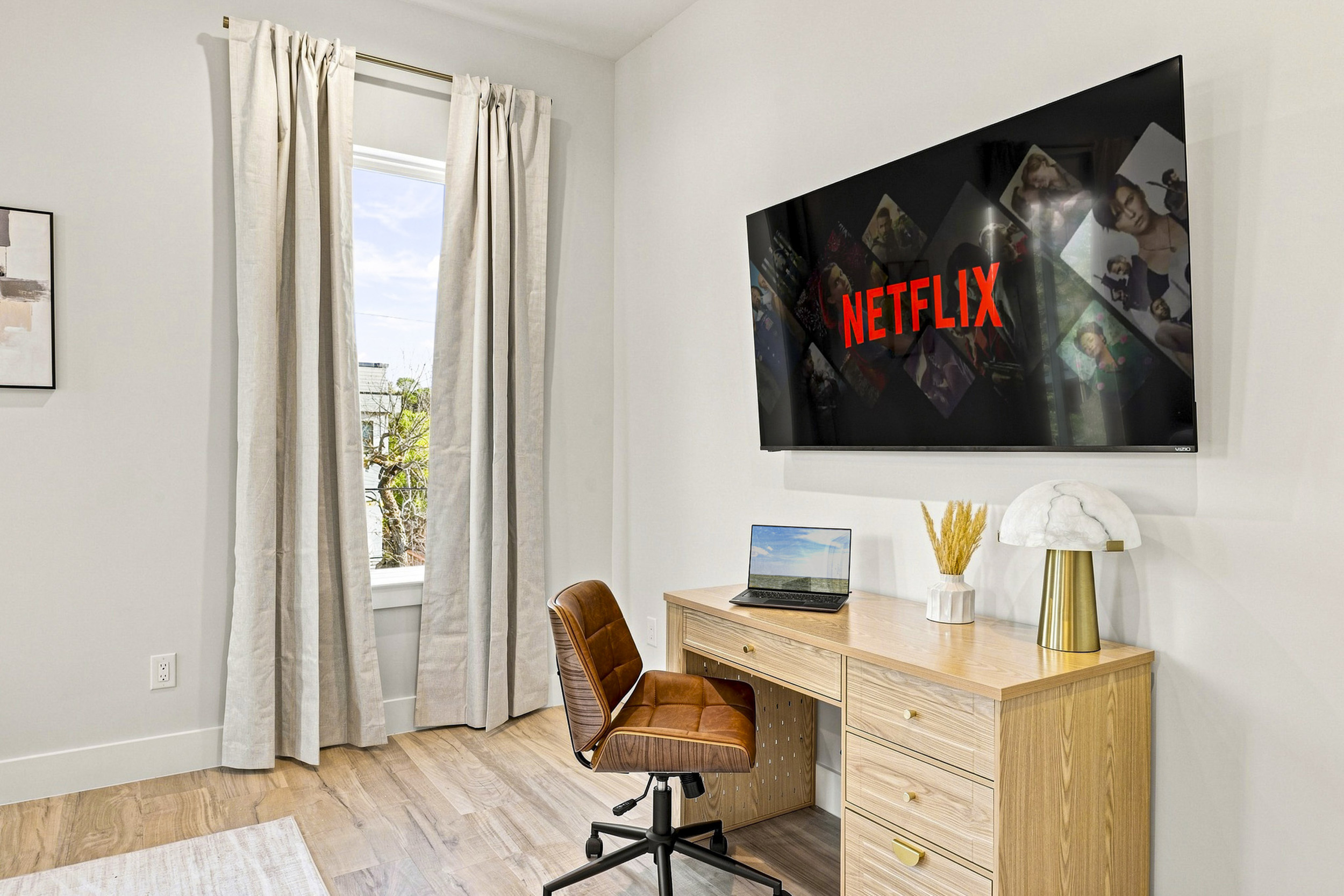 Bright space with a sleek desk, perfect for work or binge-watching!
