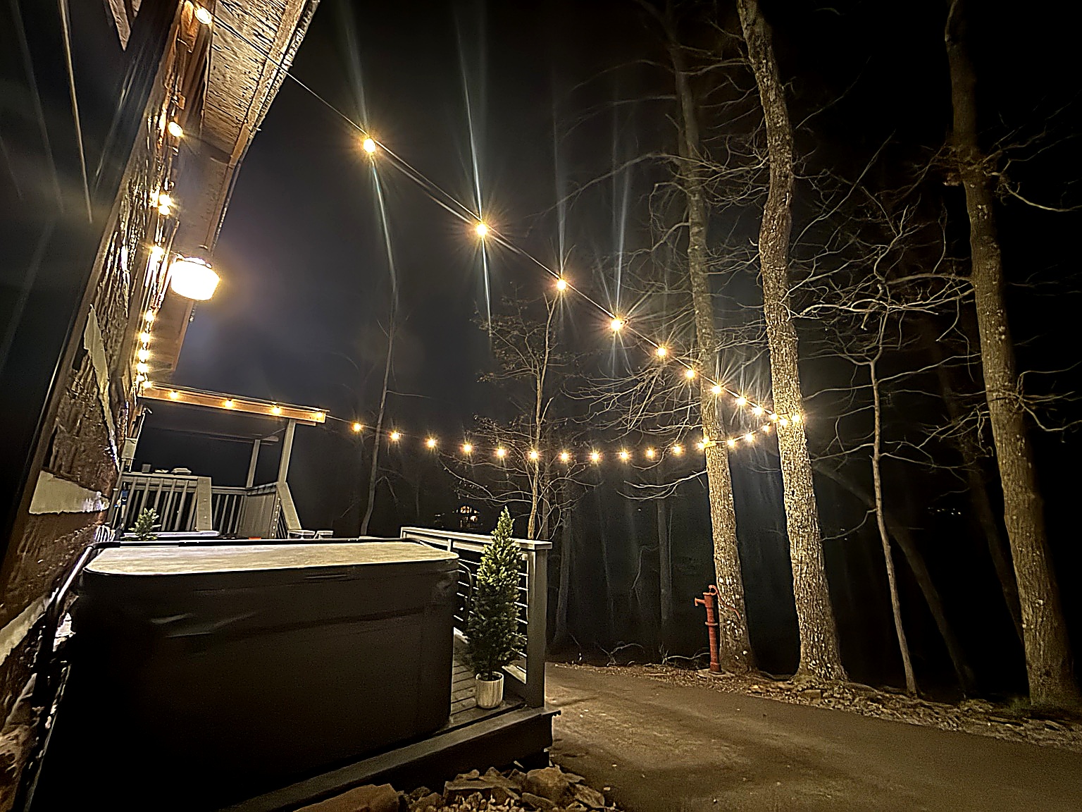 Private outdoor space nestled under warm string lights, offering peaceful mountain views duringbthe day…the perfect spot to relax and unwind.