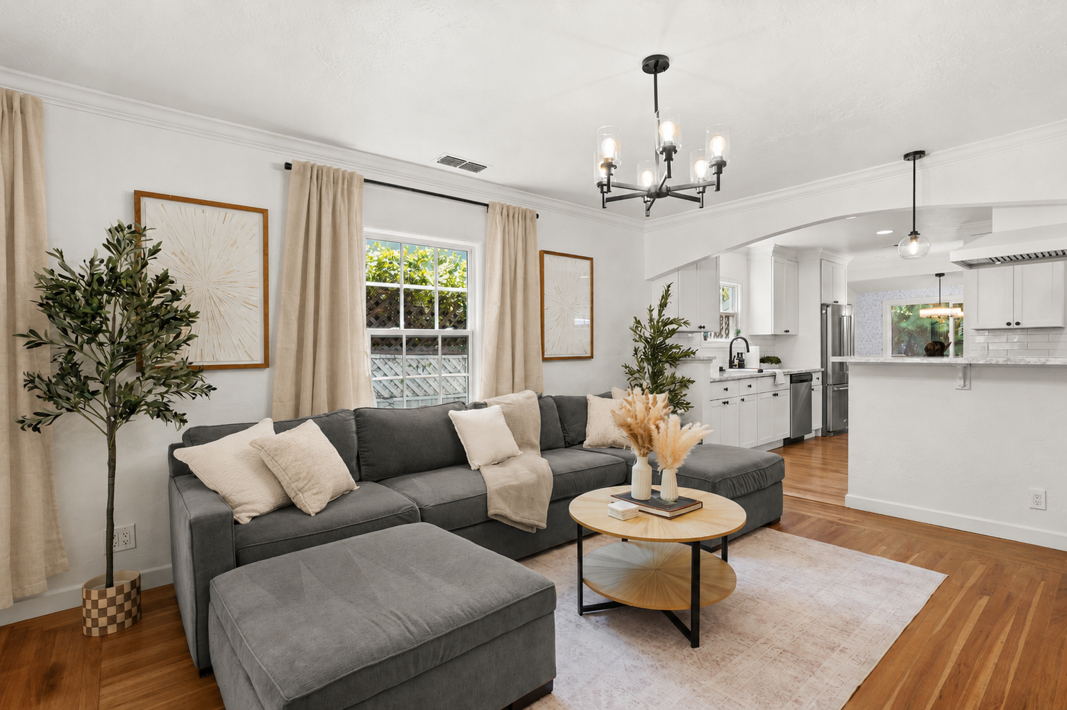 Bright, inviting living room with cozy seating, modern decor, natural light, and a Smart TV for relaxing nights in.