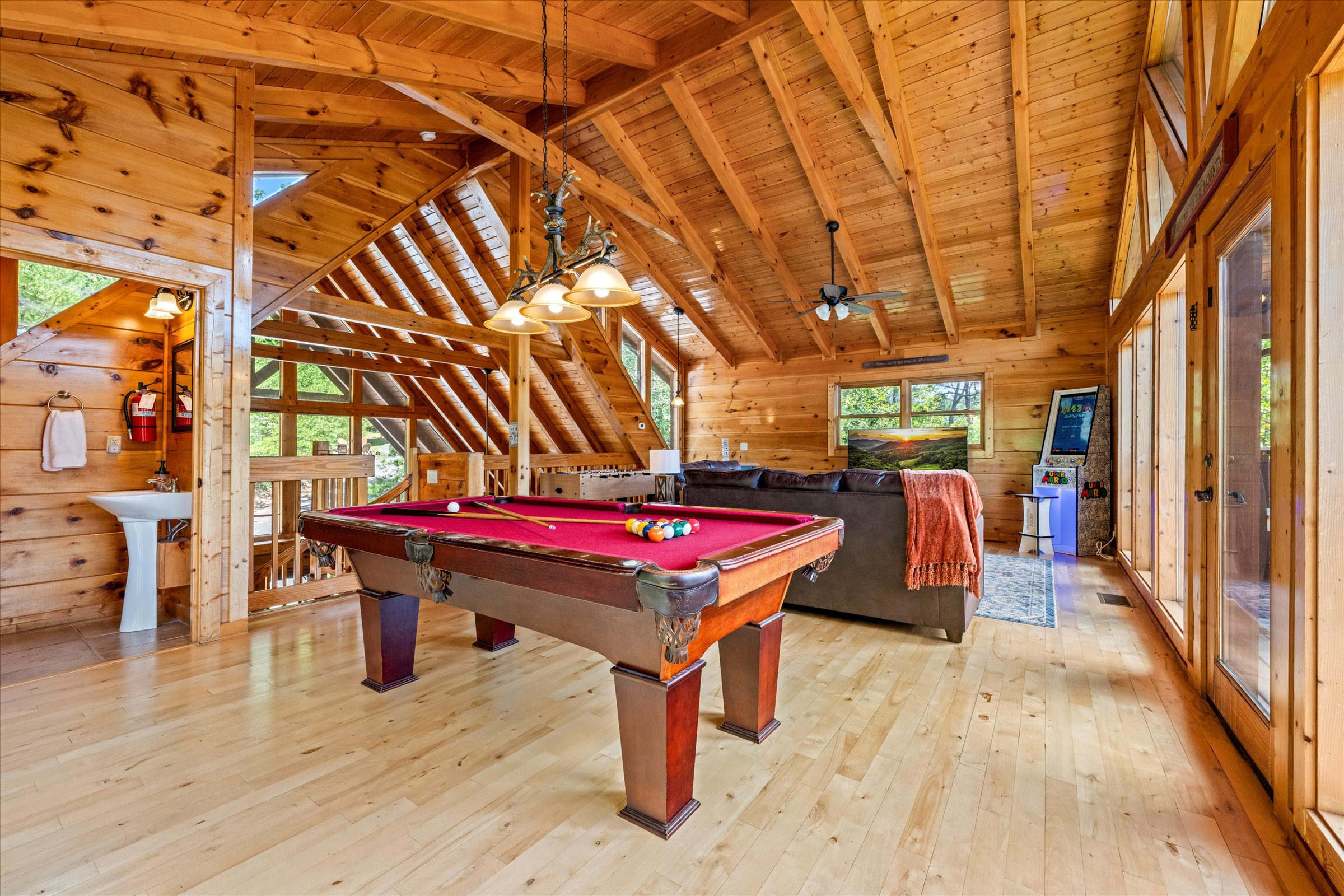 Game, relax, and sleep—loft includes a sleeper sofa and half bath for convenience.