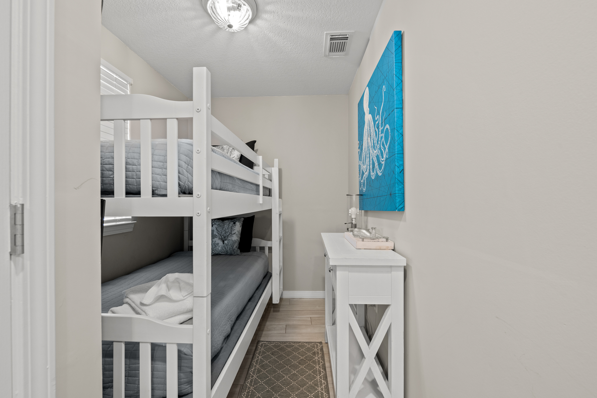 Bunk bedroom w/ crisp white beds, great for kids or extra guests.