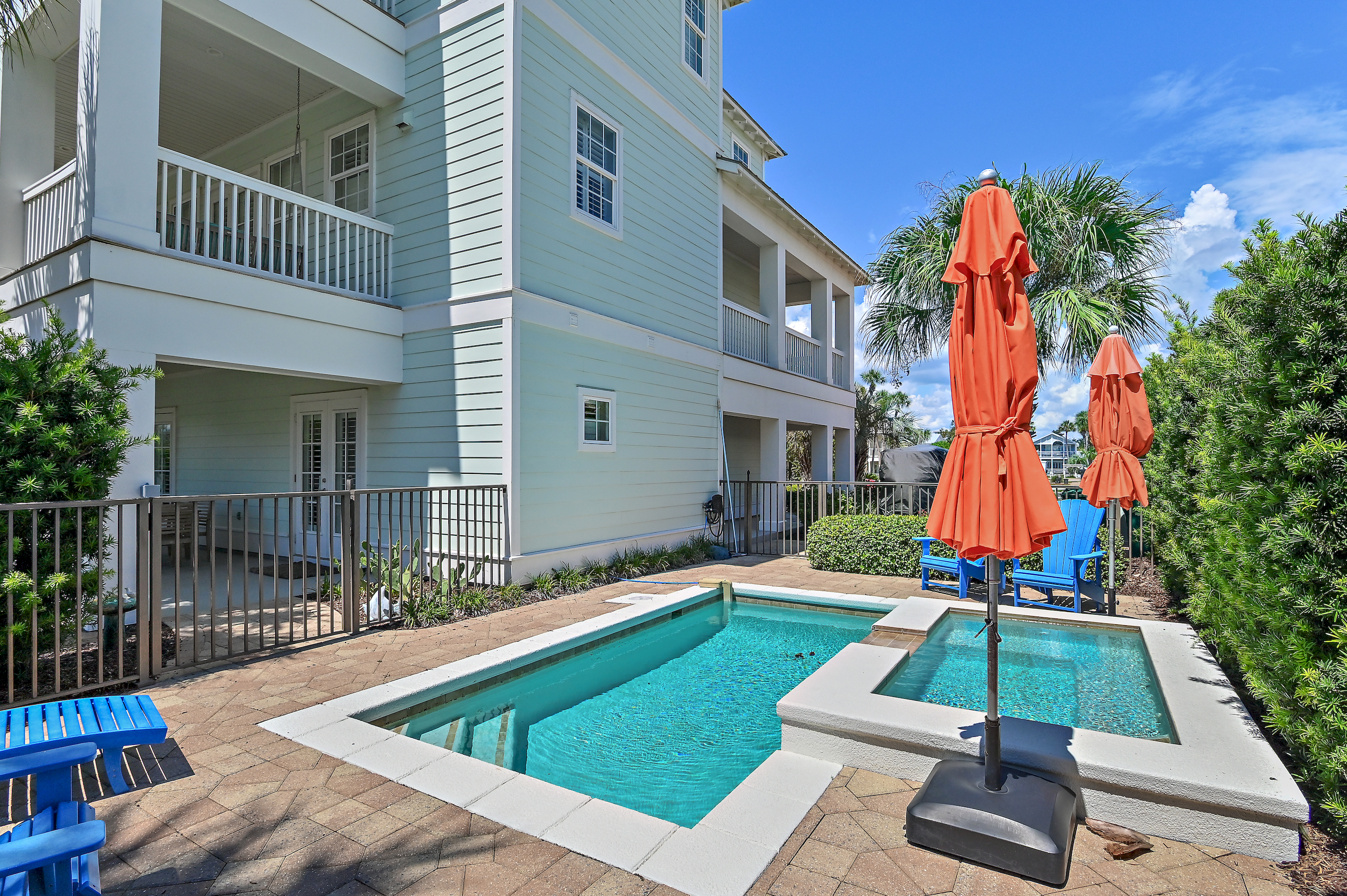 Enjoy sunny afternoons by the private pool and spa, surrounded by tropical palms and colorful coastal touches. The perfect place to relax, unwind, and make unforgettable 30A vacation memories.