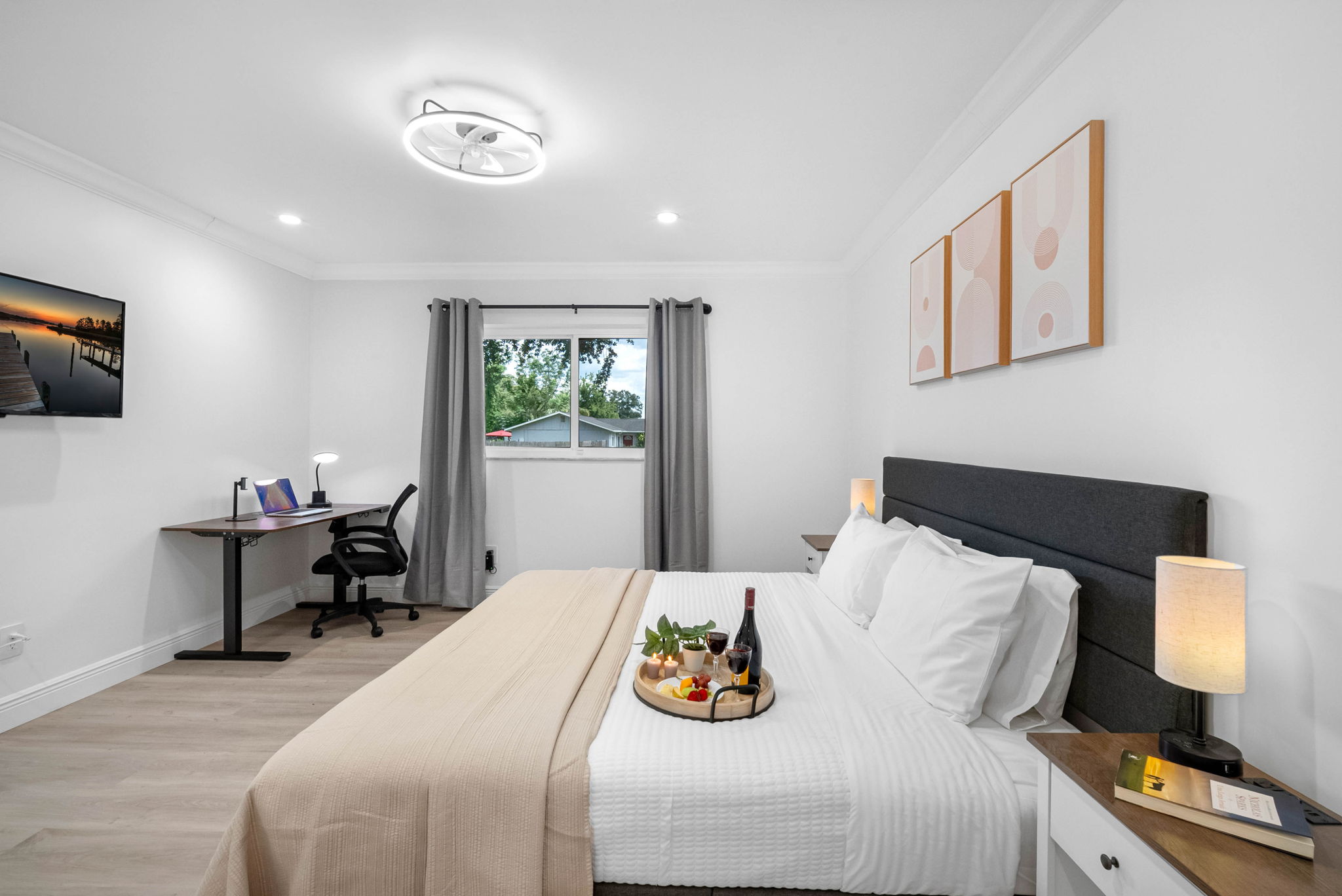 Stretch out on the plush king-size bed in this serene, hotel-inspired bedroom with fresh white linens and cozy lighting.