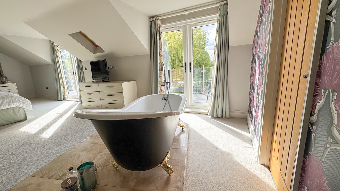Grouse roll top free standing bath with view into garden