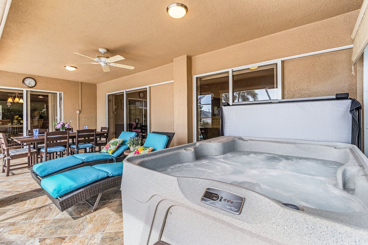 Inviting outdoor lounge and dining area with relaxing hot tub nearby!