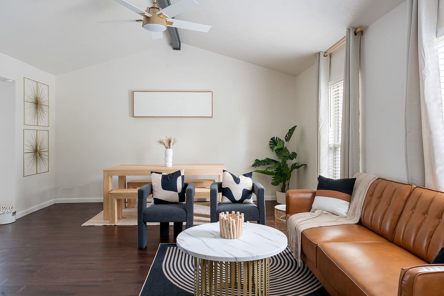 Unwind in this bright and airy living room, complete with a stylish sofa and a modern coffee table. The ceiling fan adds comfort to this space.