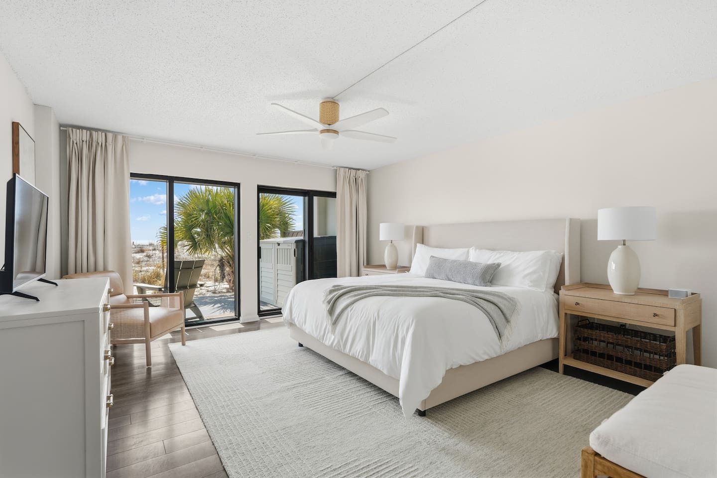 Primary bedroom has king bed and access to private patio