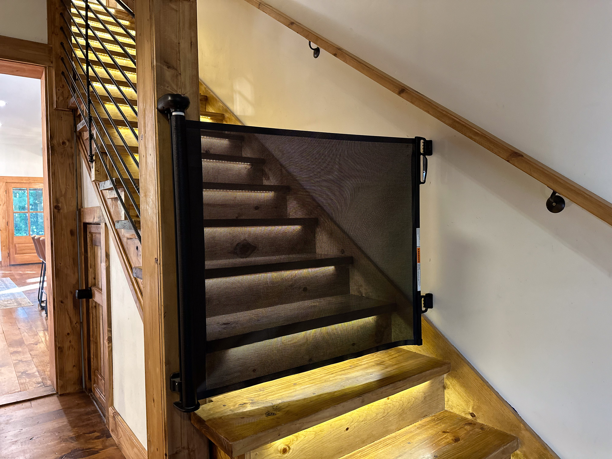 Retractable safety gates at the top and bottom of stairs ease your mine on  vacations with little ones