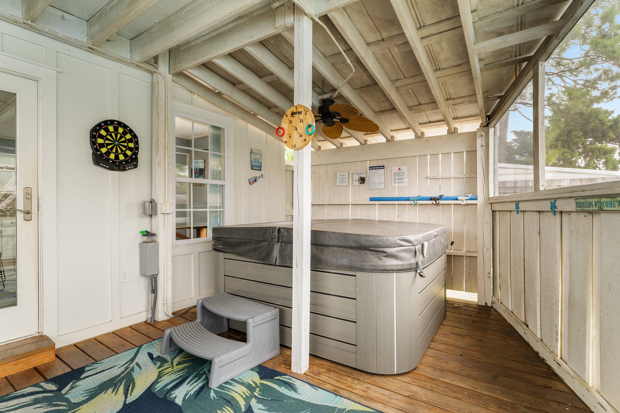 Covered hot tub, dartboard, sunroom interior