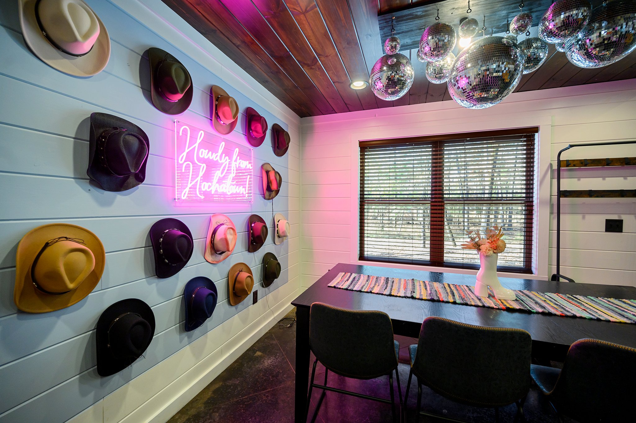 Savor your meal in a space full of Disco Cowboy charm, with windows that frame a beautiful view of the trees.