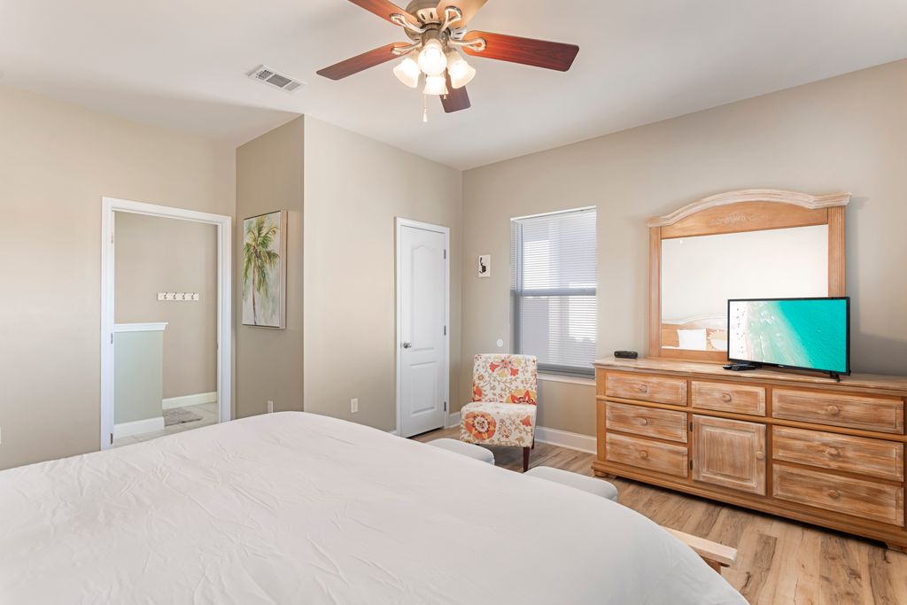 Second Floor: Bedroom 2 – Relaxing coastal-themed bedroom with nightstand, dresser, and TV for comfort.
