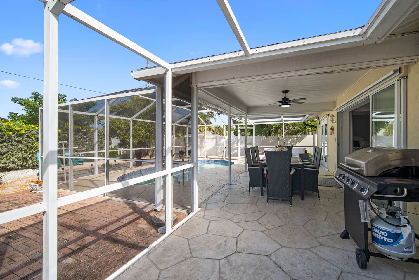 Grill and the dining table on the screened lanai