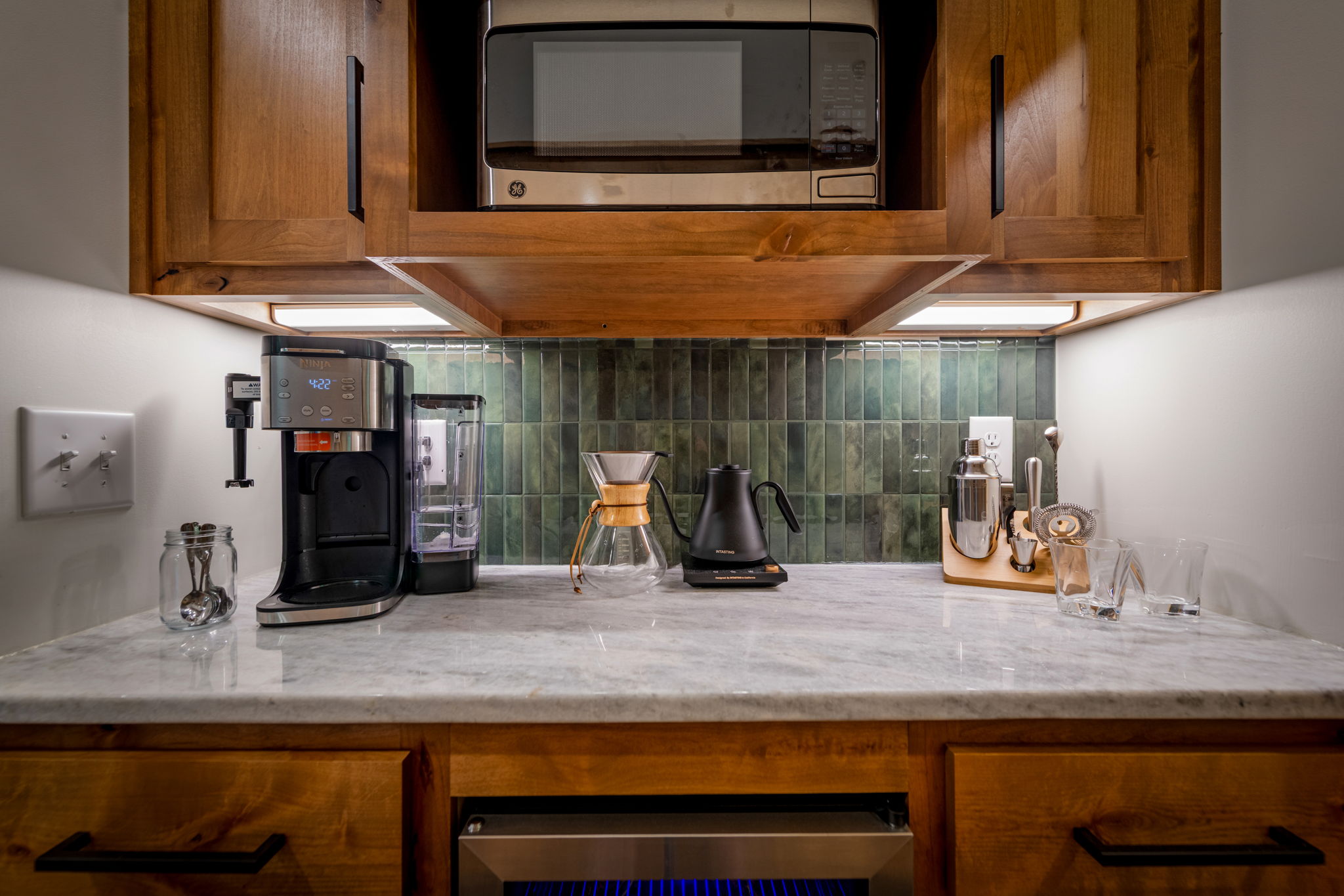 Coffee bar with kettle and pour over, Keurig and drip coffee options. And mixing bar station for cocktails.