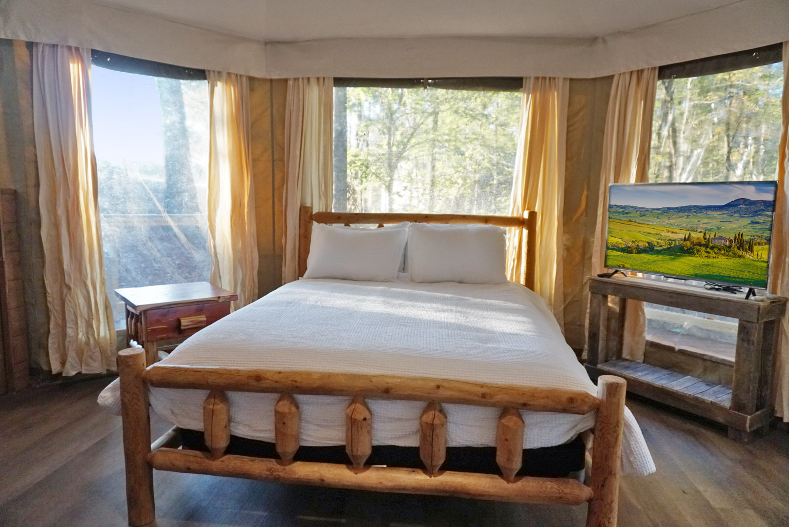 Sun-drenched room with window views and a comfy log bed awaits your getaway!