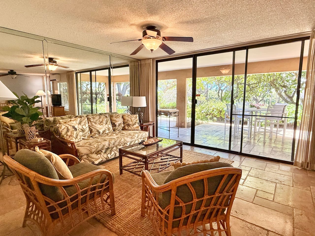 Relax in this living room on the comfortable chairs or couch, while looking outside. Easy access to the lanai.