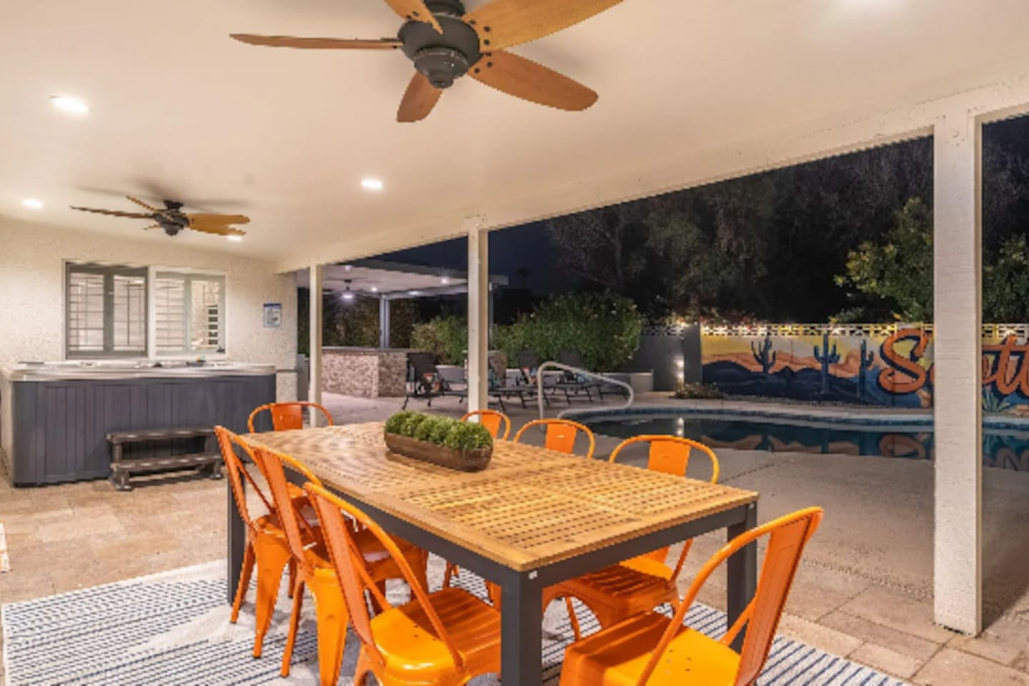 Seating for eight under the stars, steps from the pool and hot tub — dinner here comes with its own view.