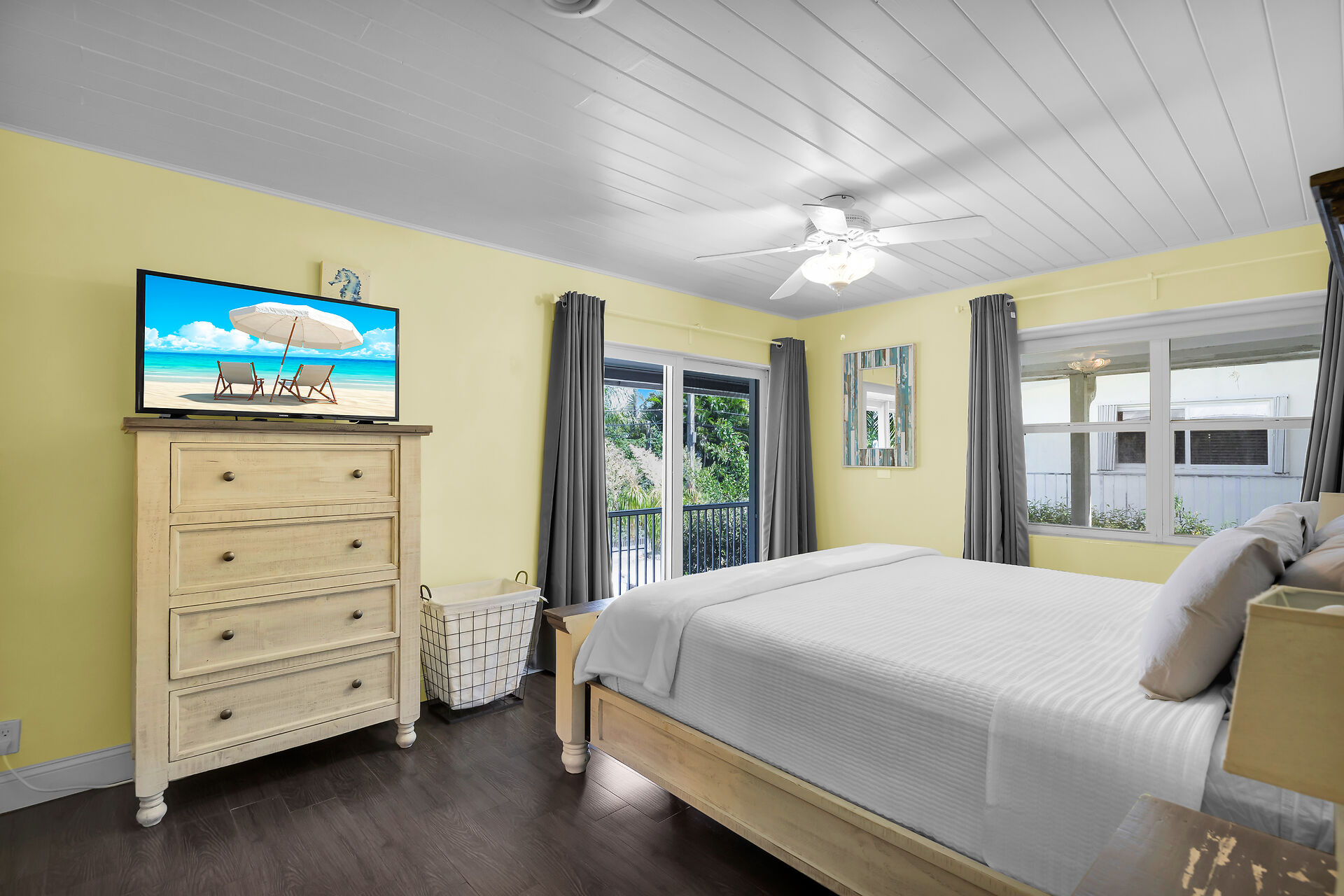 King size bed with private patio in primary bedroom