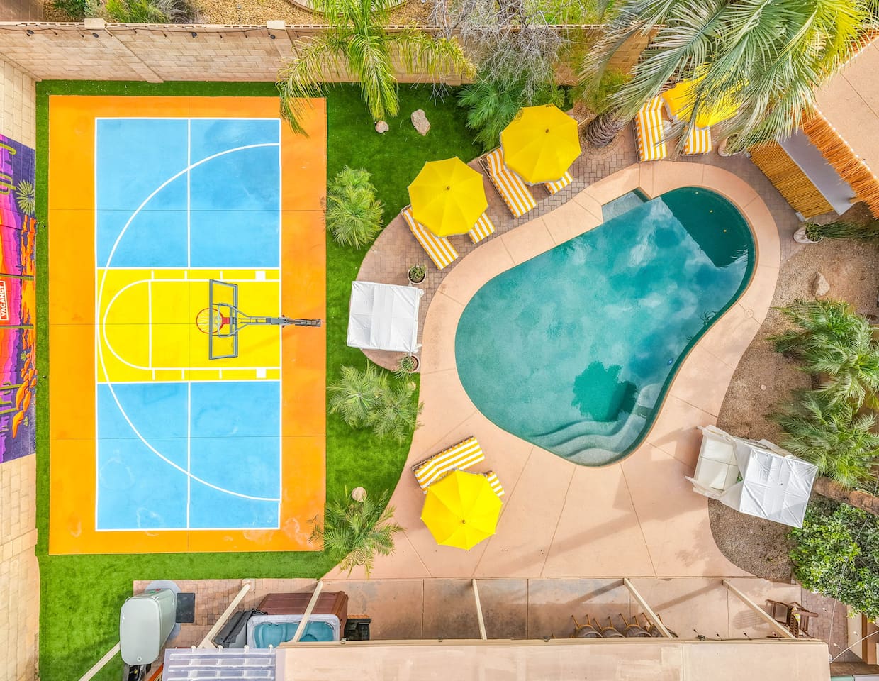 Straight-down drone view captures the pool and sport court.