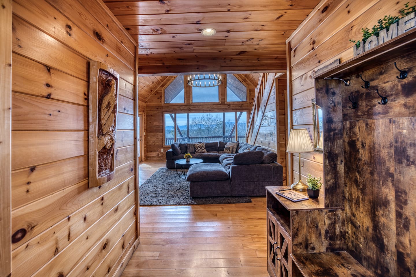 Entering from the front door into the foyer, into the main living room with beautiful A-frame ceiling, wall of windows, double-sided gas fireplace, and stunning mountain views! 
