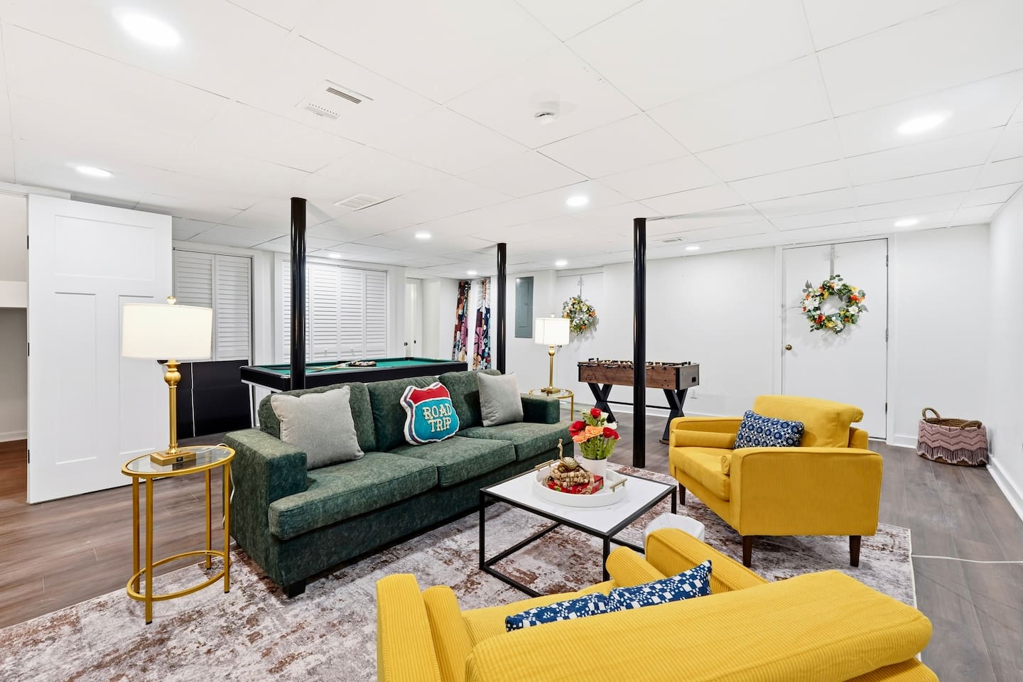 Amazing game room located in the basement, featuring a pool table, foosball table, and a stylish bar perfect for entertaining and relaxing with friends and family.