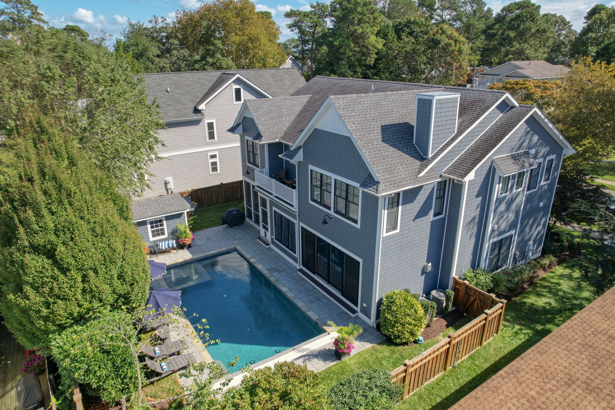 Private backyard with heated pool and upper deck